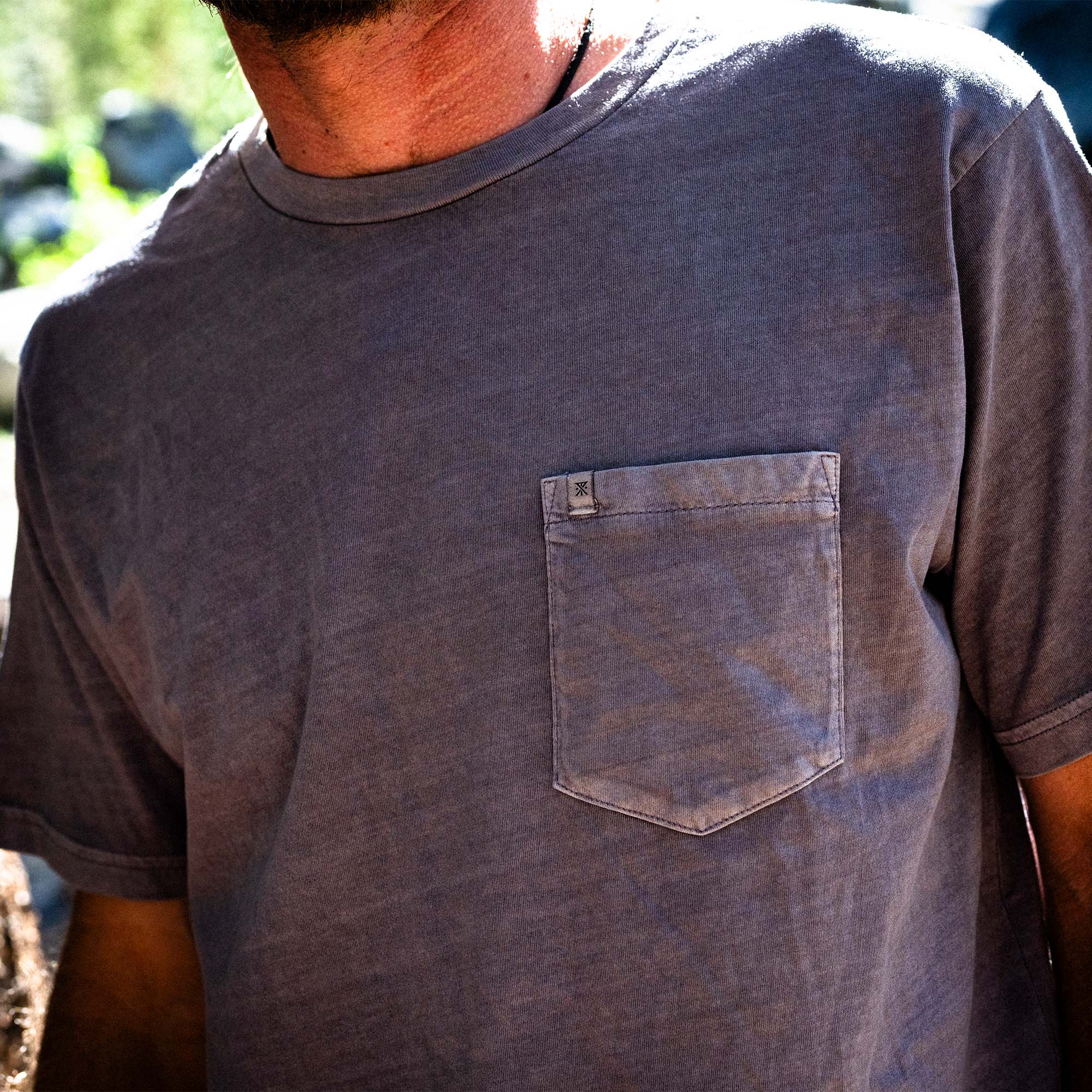 Bearded man in a rugged, 'Made To Fade' active shirt with denim sleeves, embodying Roark's adventure and travel spirit