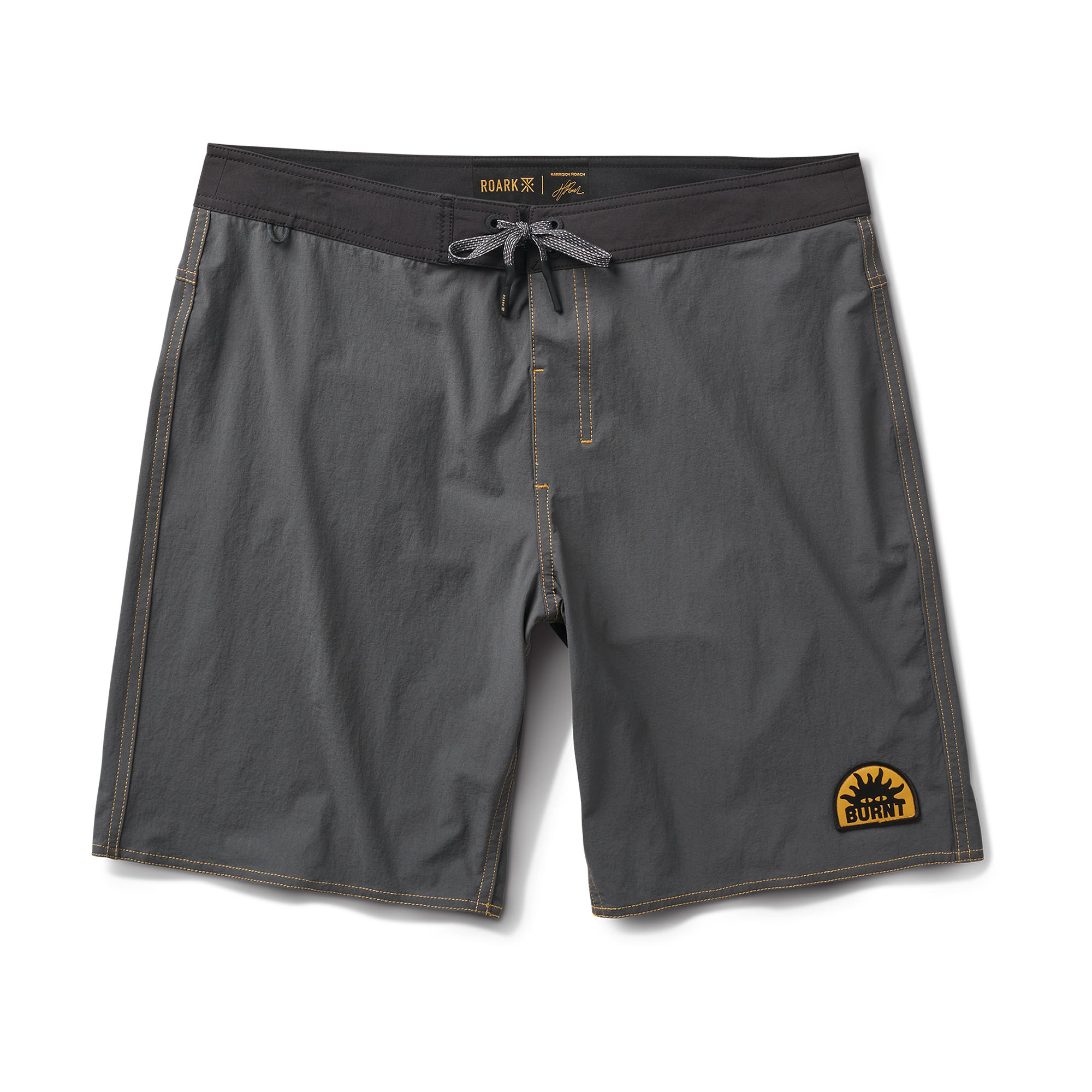 Roark boardshorts and surfboard set against a scenic surfing backdrop, symbolizing adventure and freedom in the great outdoors.