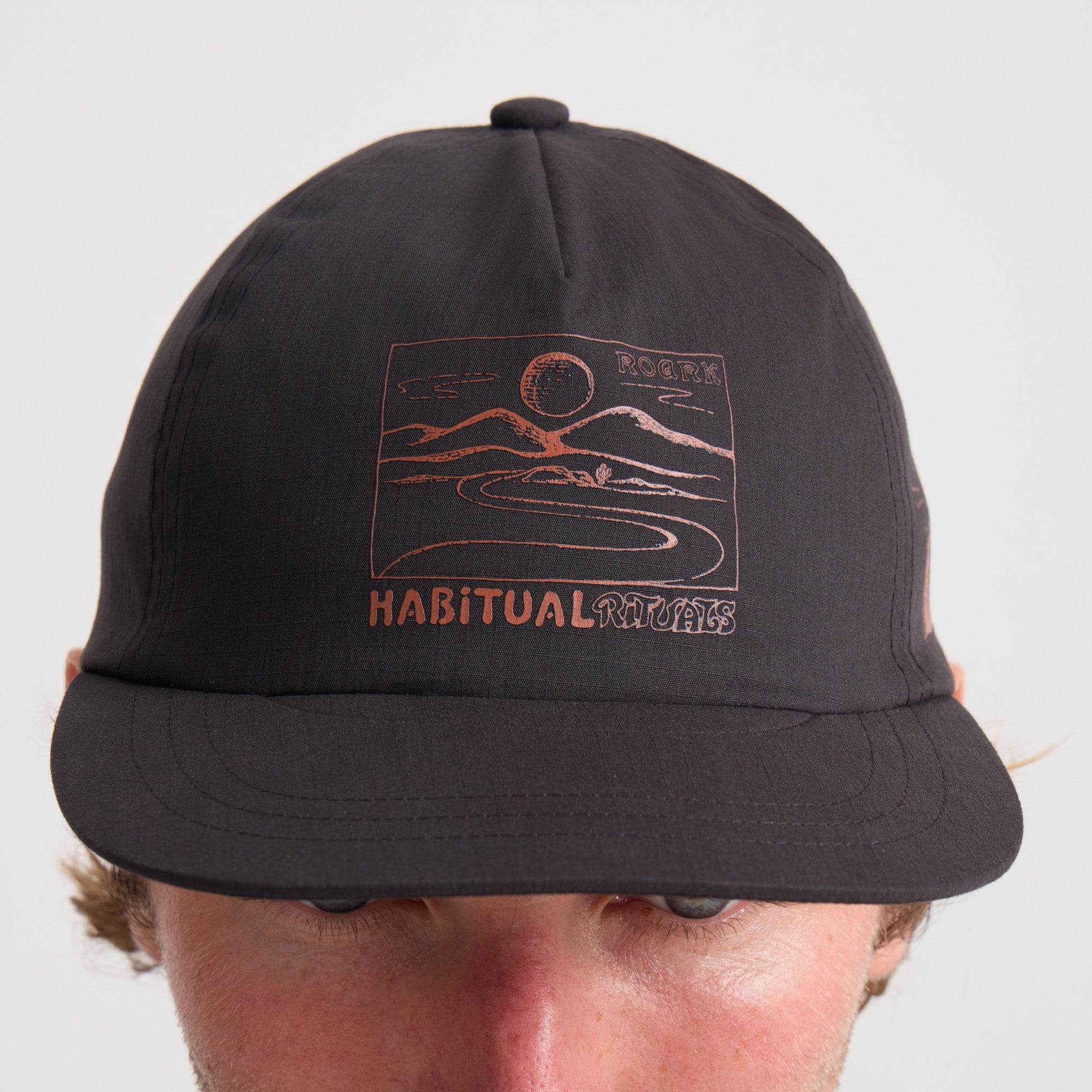 Black cricket cap, ideal for adventure and travel, from Roark's outdoor collection.