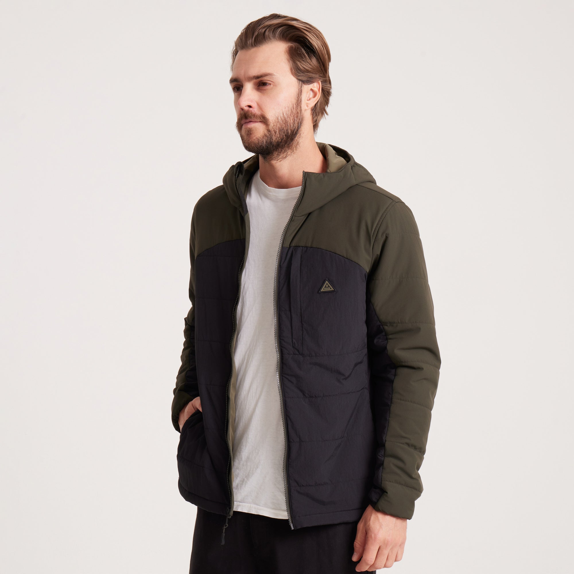 Angled view of a green and black hooded jacket, showcasing its stylish and functional design.
