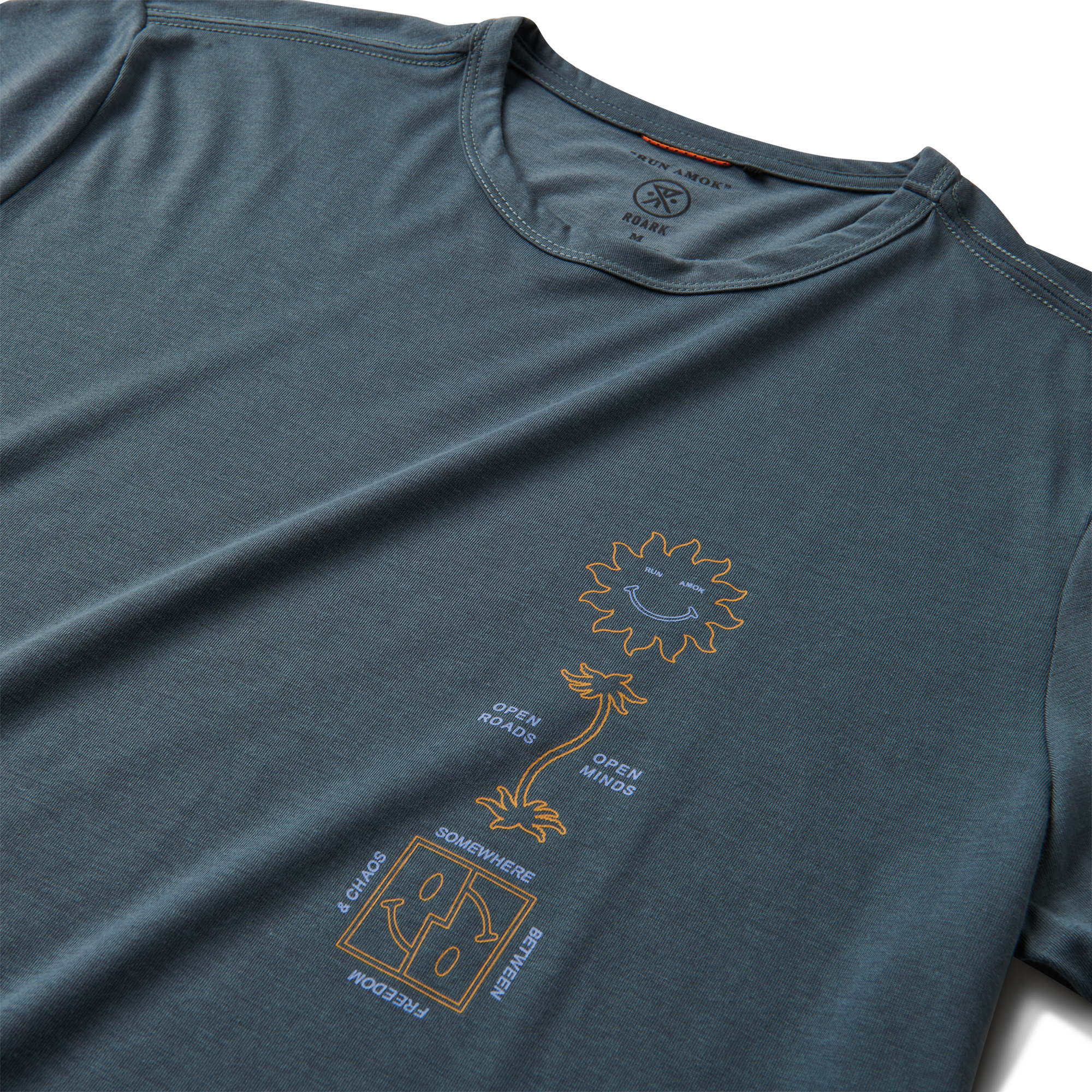 A close-up image of the Roark Mathis Core Short Sleeve Tee in blue, showcasing the details and craftsmanship. Shop the official Roark store now.