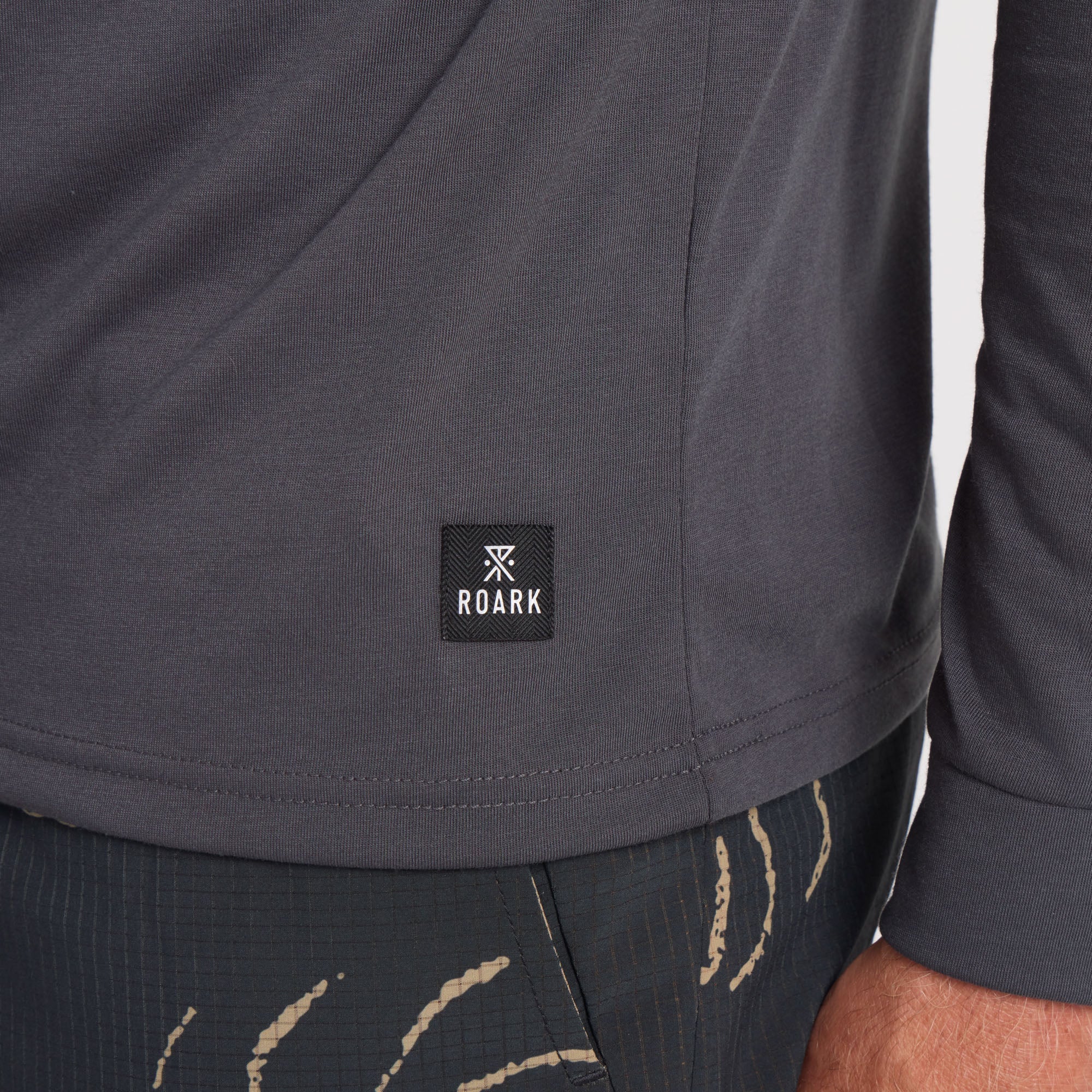 Long-sleeved active shirt designed for adventure and travel by Roark, featuring durable sleeves perfect for outdoor activities.