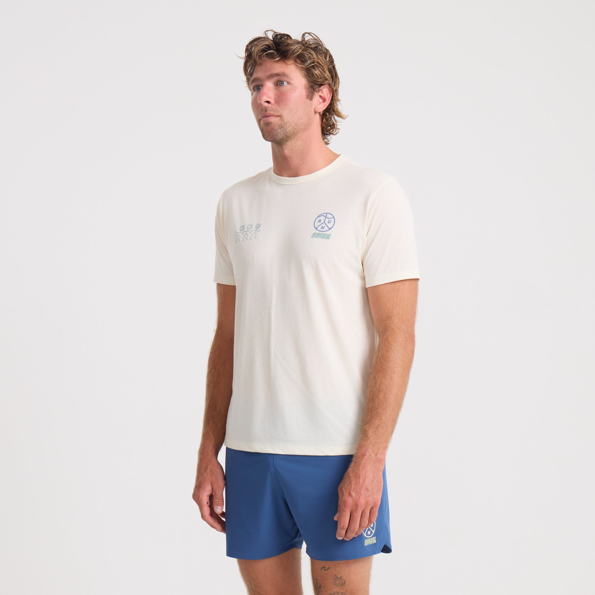 Active man wearing blue Roark sleeve shirt paired with boardshorts in an outdoor adventure setting