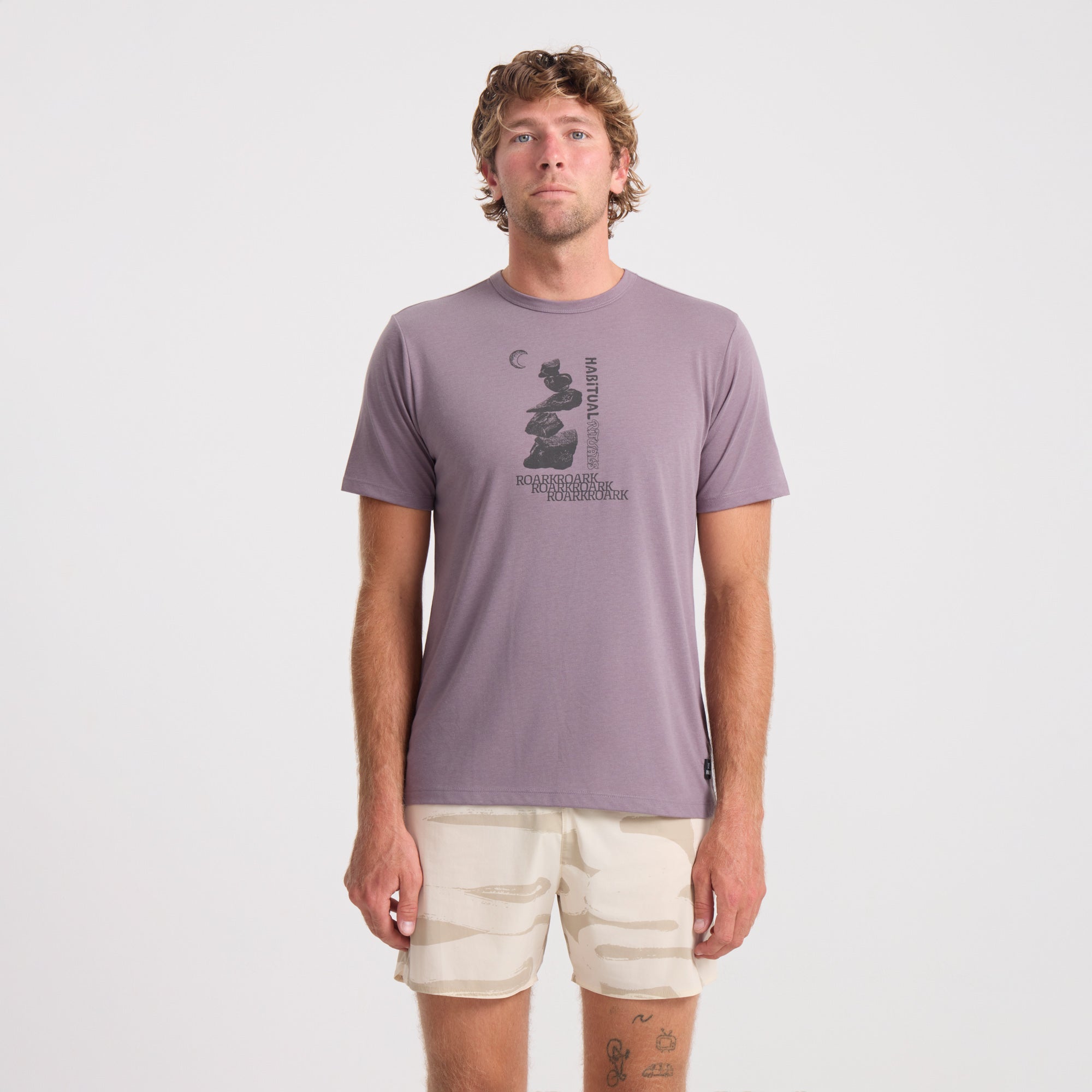 Active man wearing a Roark long sleeve performance shirt, ideal for outdoor adventures and travel.