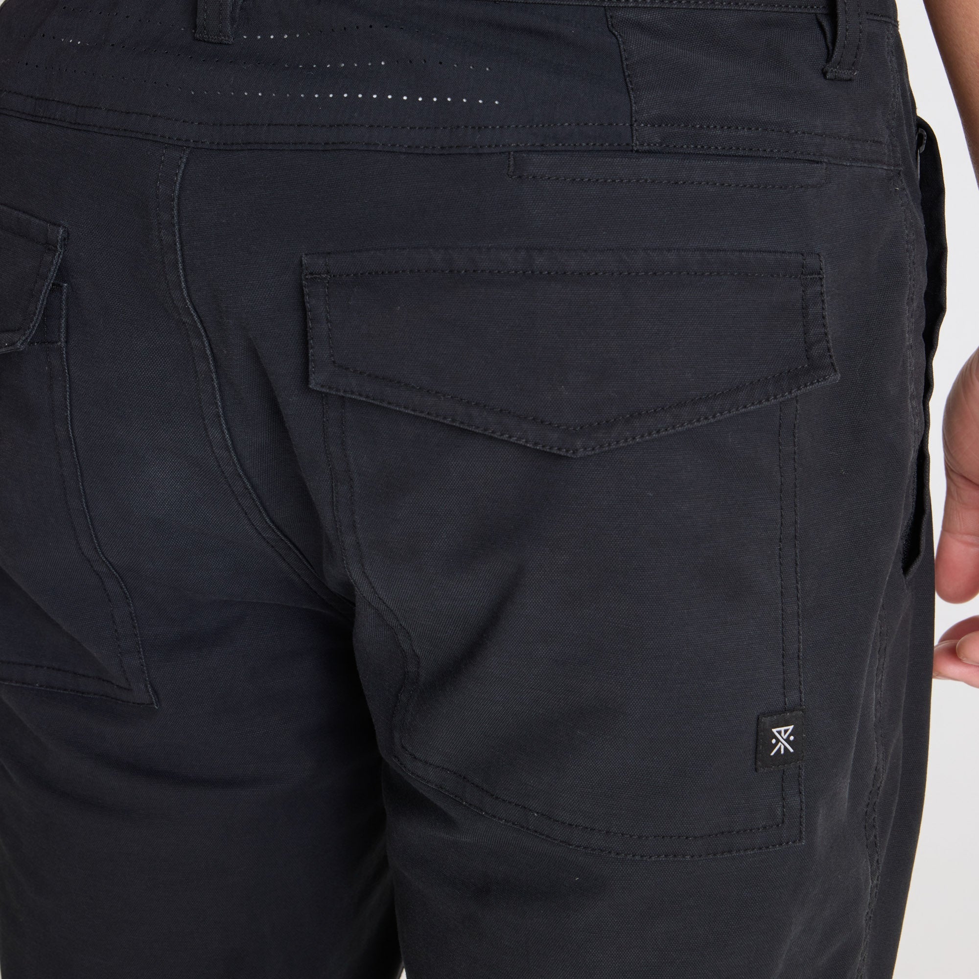 Roark adventure-ready black cargo pants styled for outdoor exploration and travel, showcasing durability and functionality.