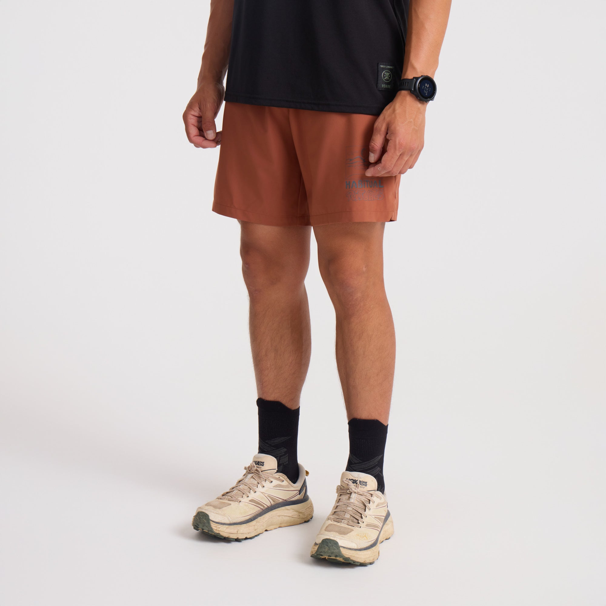 Roark men's active and adventure-ready boardshorts, stylish Bermuda shorts, and trunks in an outdoor setting, highlighting the calf area for mobility and comfort.