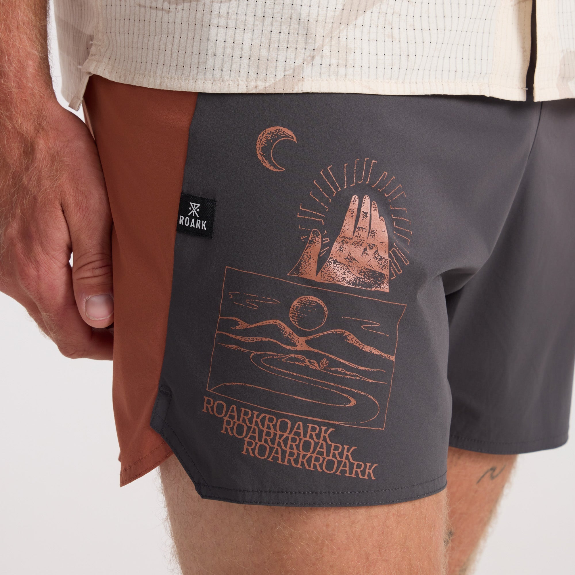 Adventure-ready boardshorts by Roark, styled for both water and leisure, with surrounding boating equipment enhancing the outdoor travel vibe.
