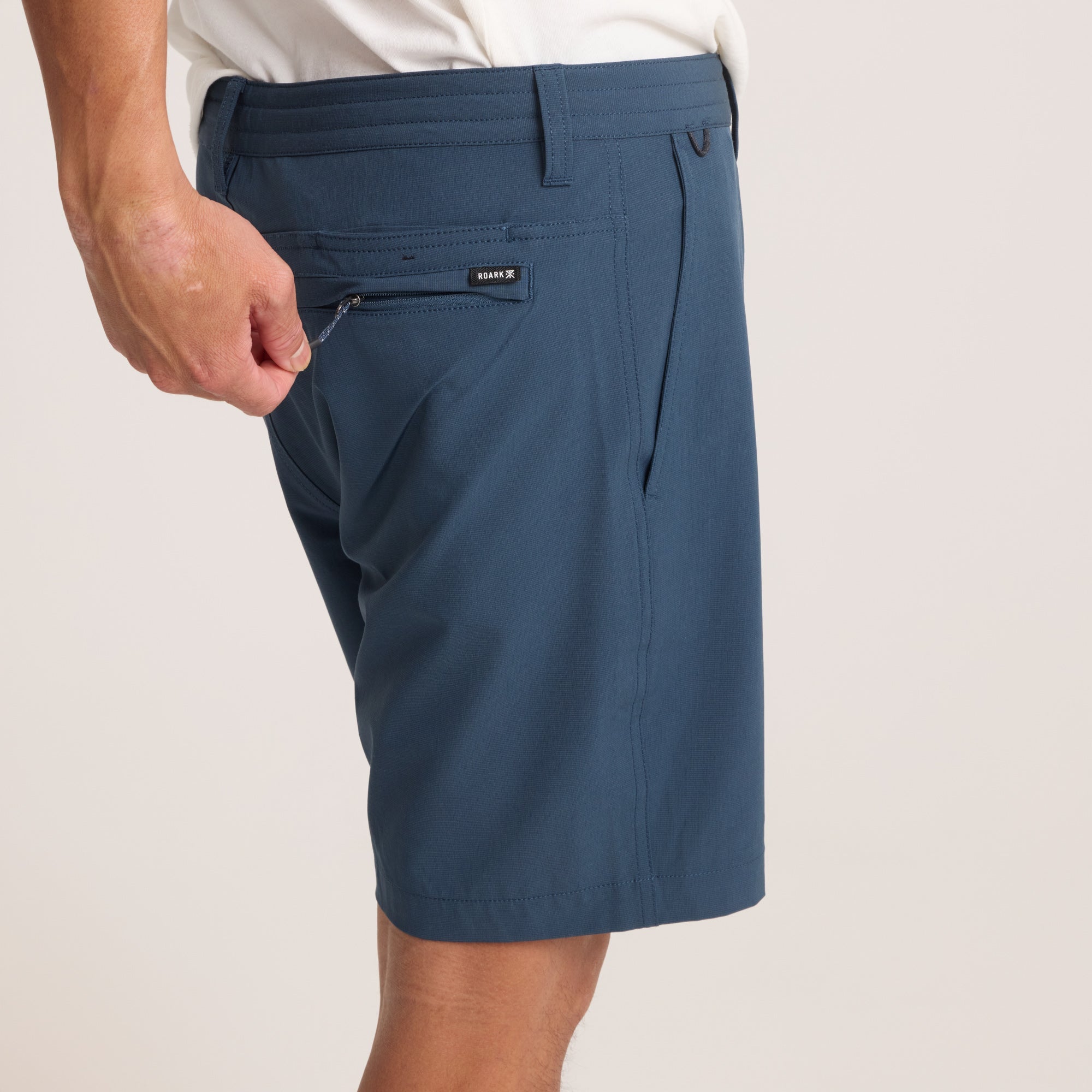 Close-up of navy hybrid shorts on a model, emphasizing premium fabric and clean finish for a modern aesthetic.