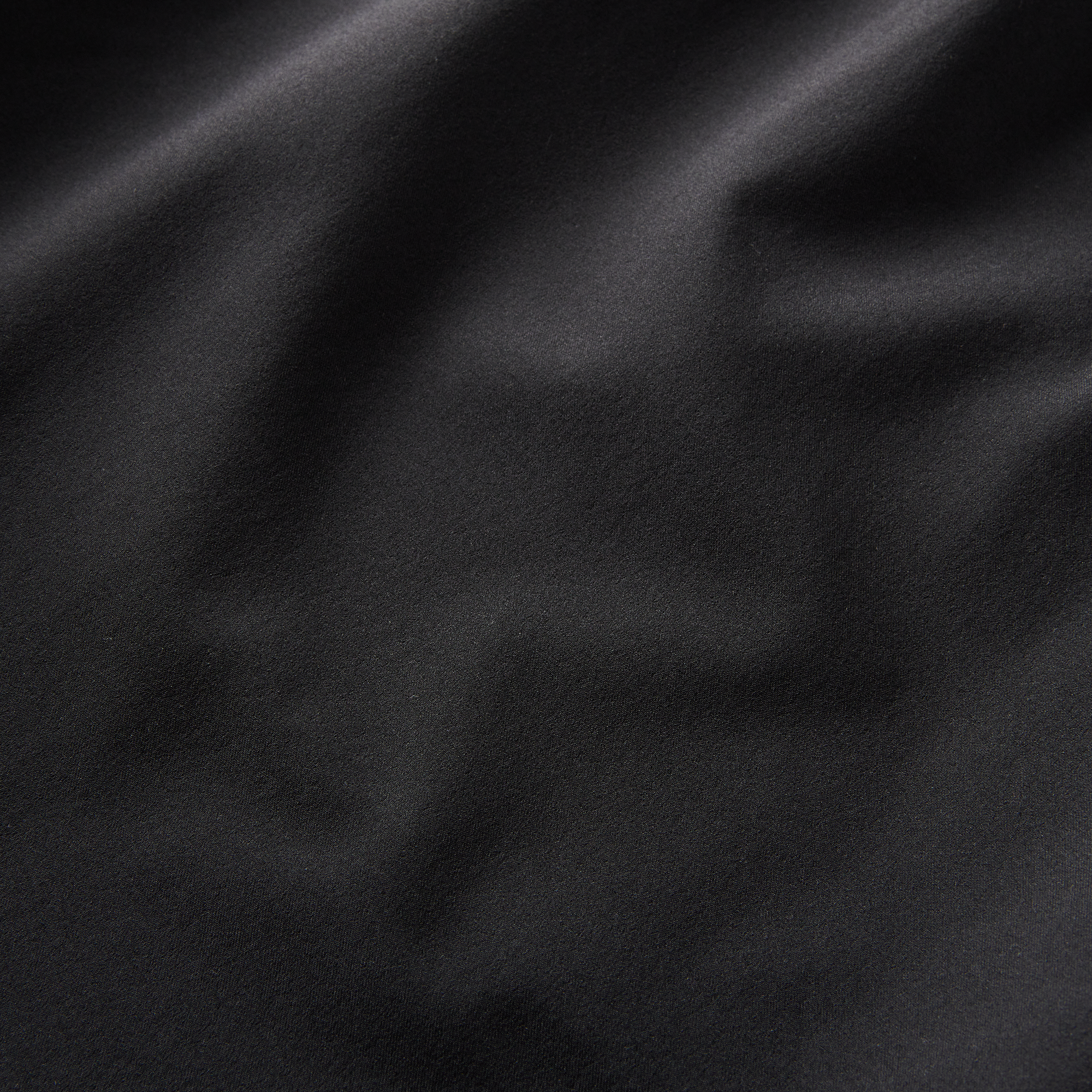 Detailed texture of the lightweight REPREVE® recycled polyester fabric with a DWR water-resistant finish, ensuring durability and performance in diverse activities.