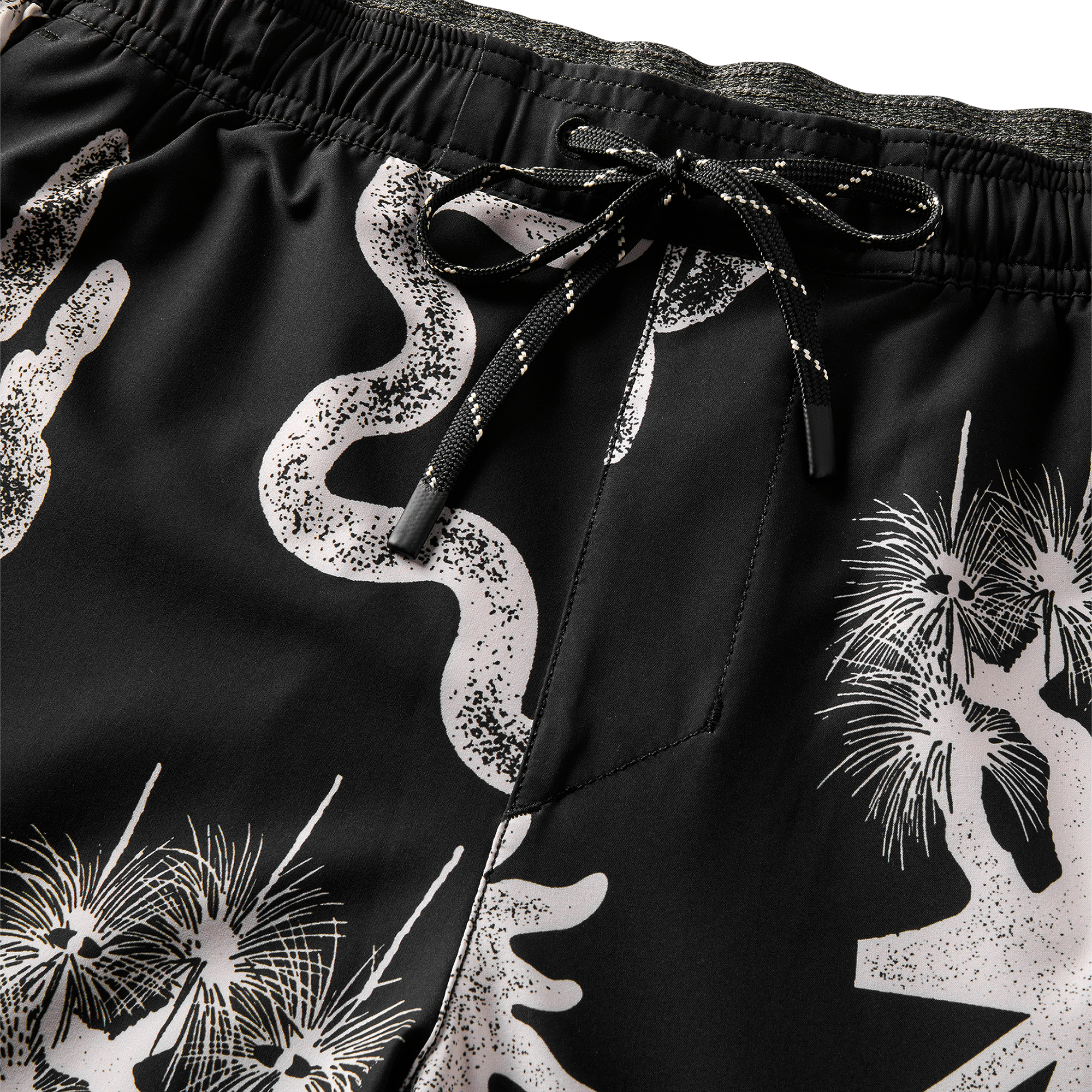 Detailed close-up of the black swim shorts' elastic waistband with adjustable drawstrings, providing a comfortable and secure fit.