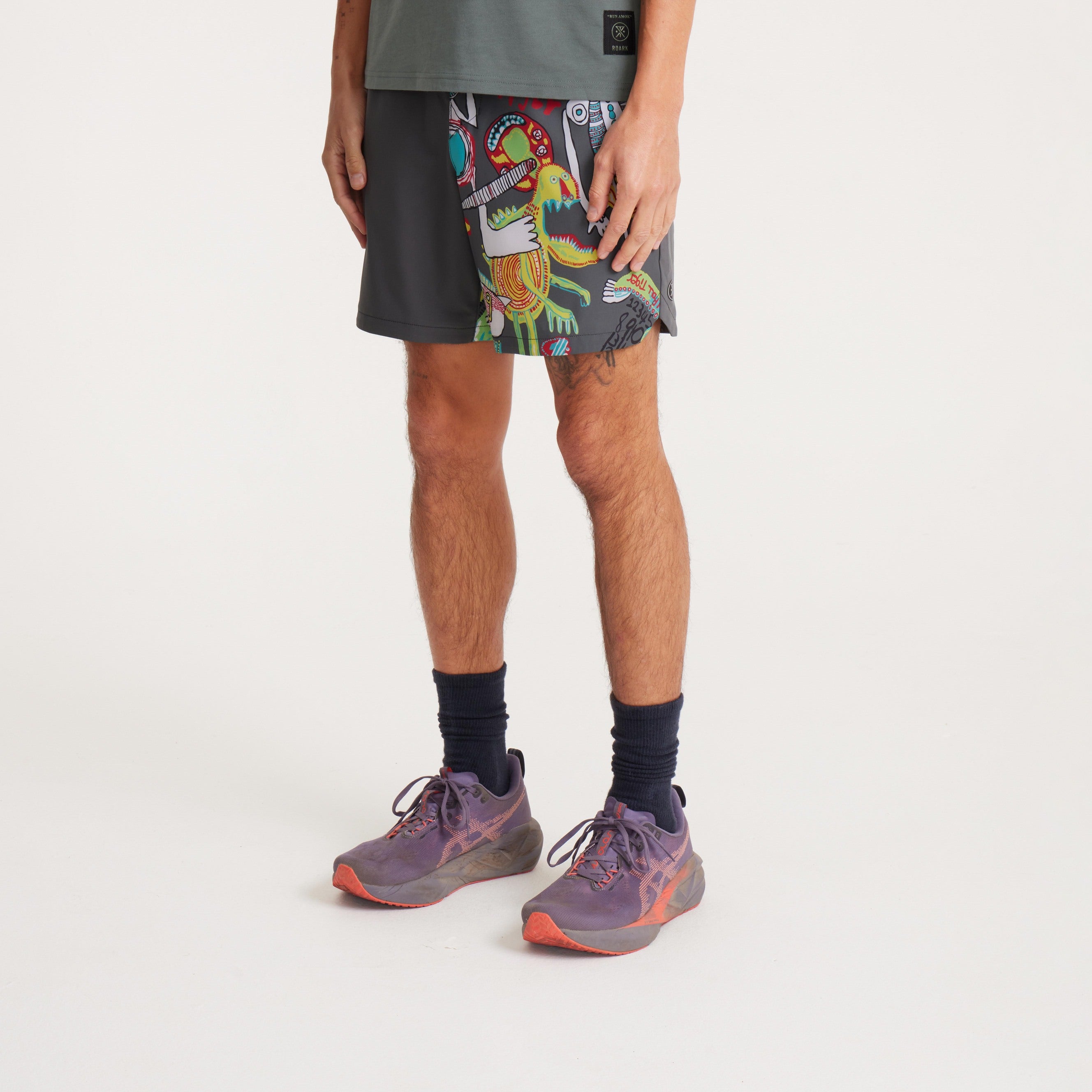 Detailed view of unique light bulb graphic on men's swim shorts, showcasing vivid colors and artistic style.