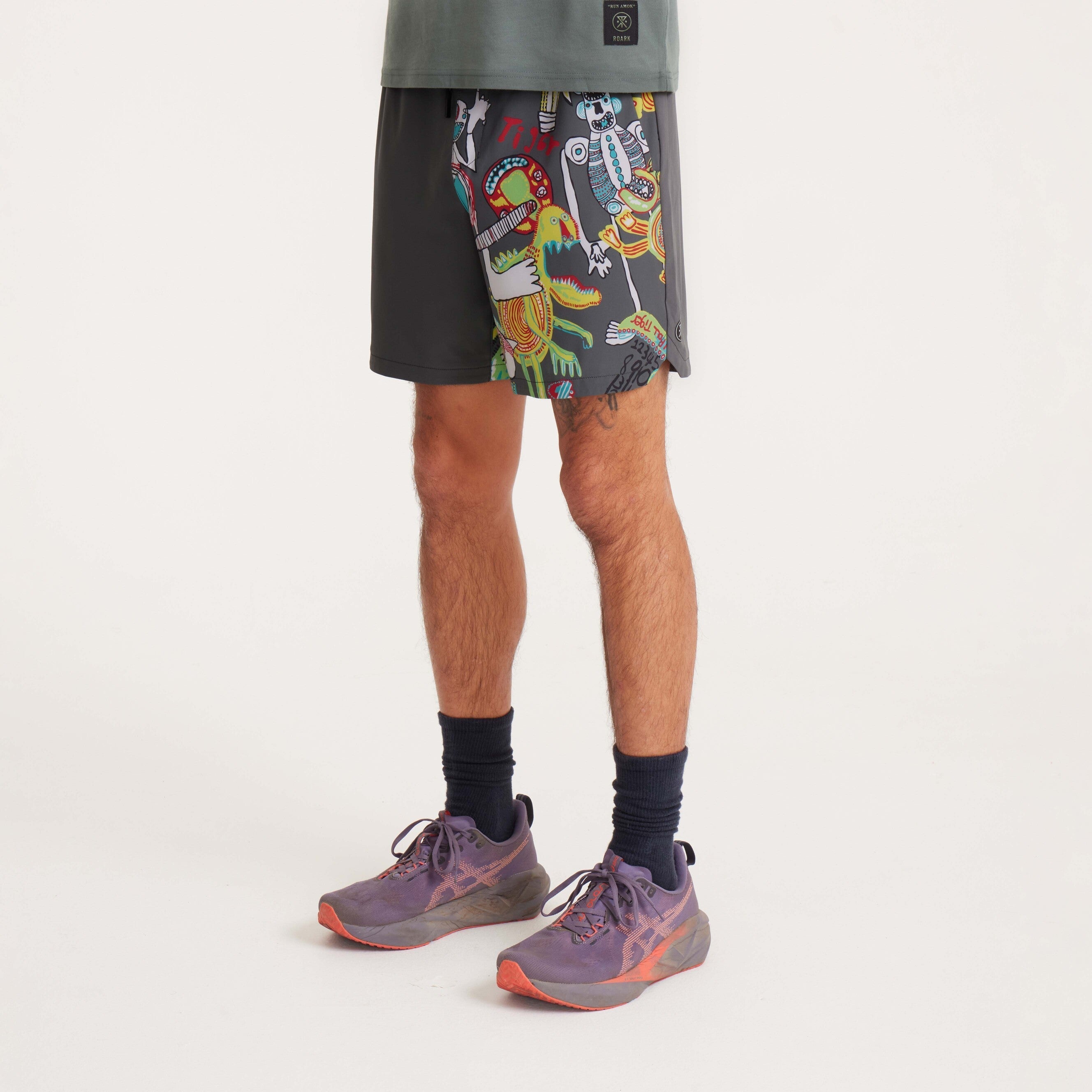Side view of men's swim shorts with a playful graphic design, showcasing zippered pocket and relaxed fit.