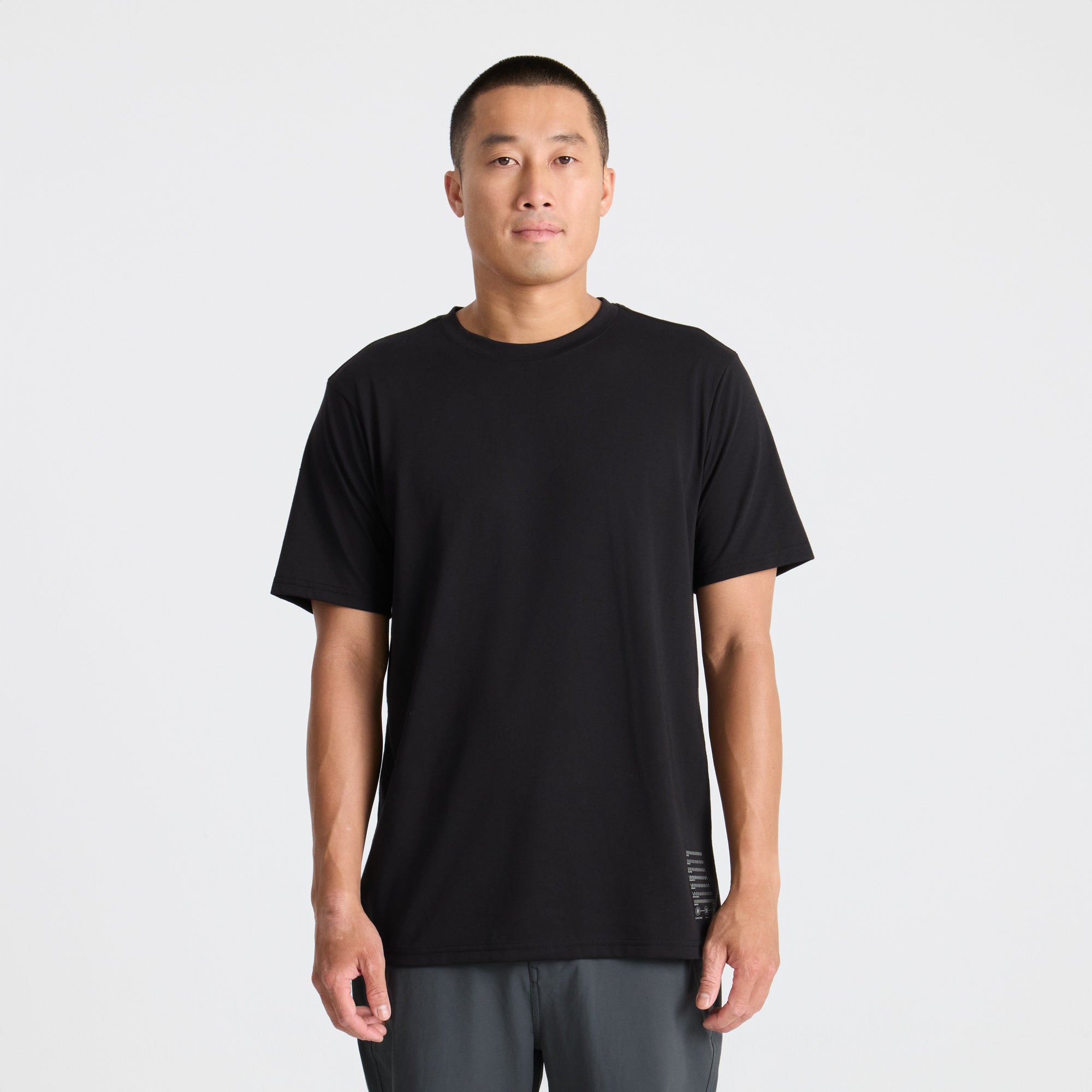 Grey active shirt with sleeves, ideal for outdoor adventures and travel, displayed on a neutral background.