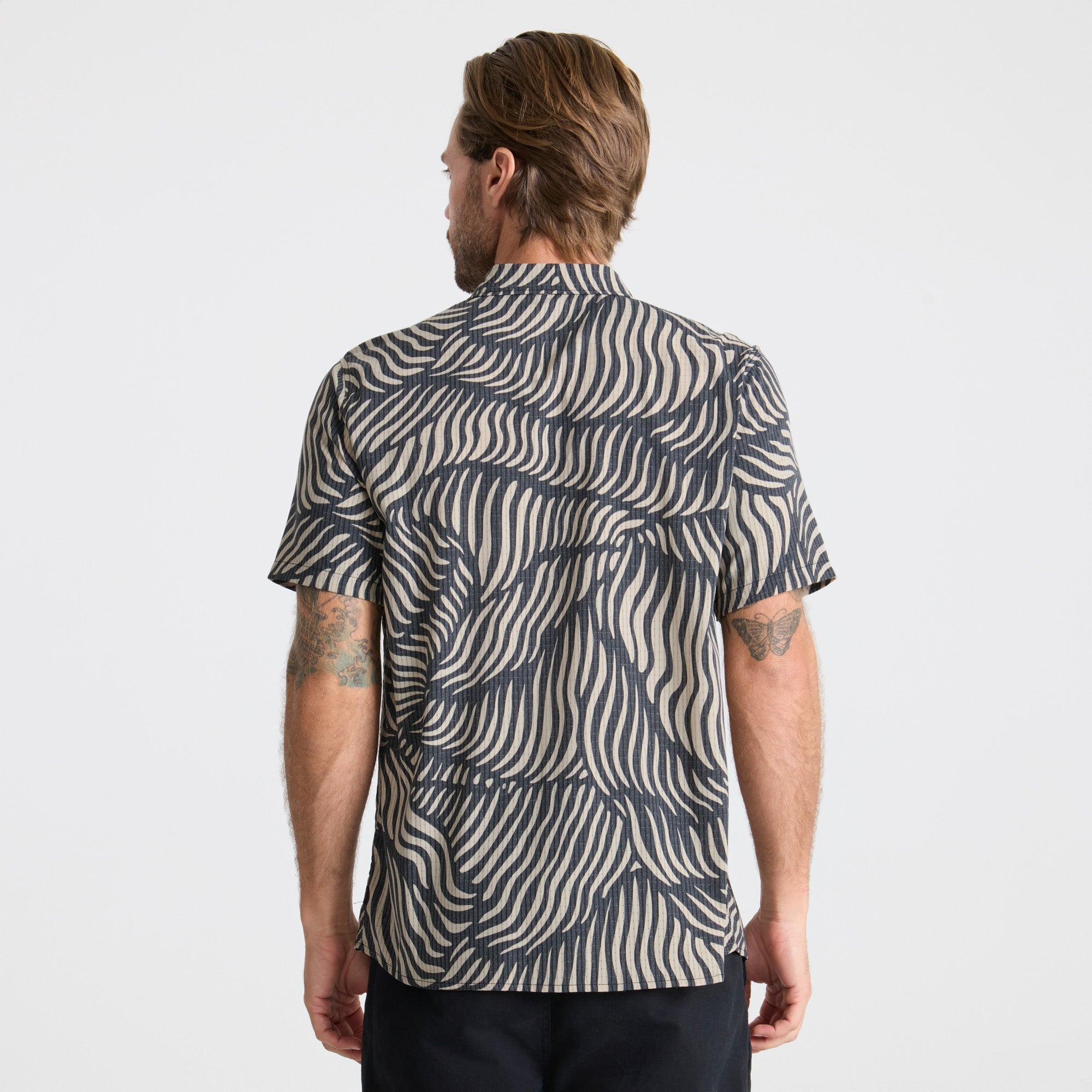 Close-up of a durable button on Roark outdoor apparel, designed for adventure and travel.