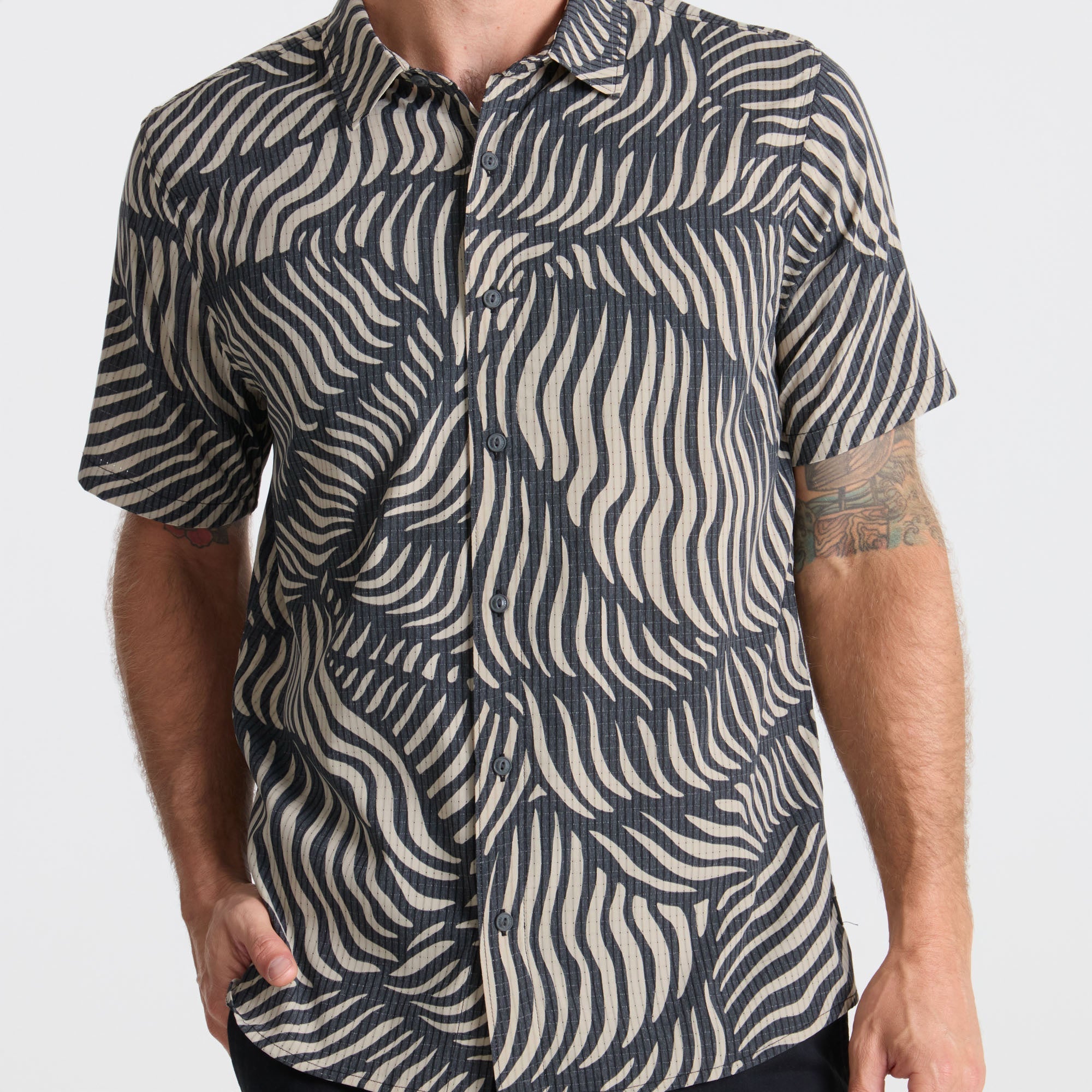 Close-up of a gray active shirt featuring detailed stitching on the collar, sleeves, and buttons, ideal for adventure and outdoor activities.