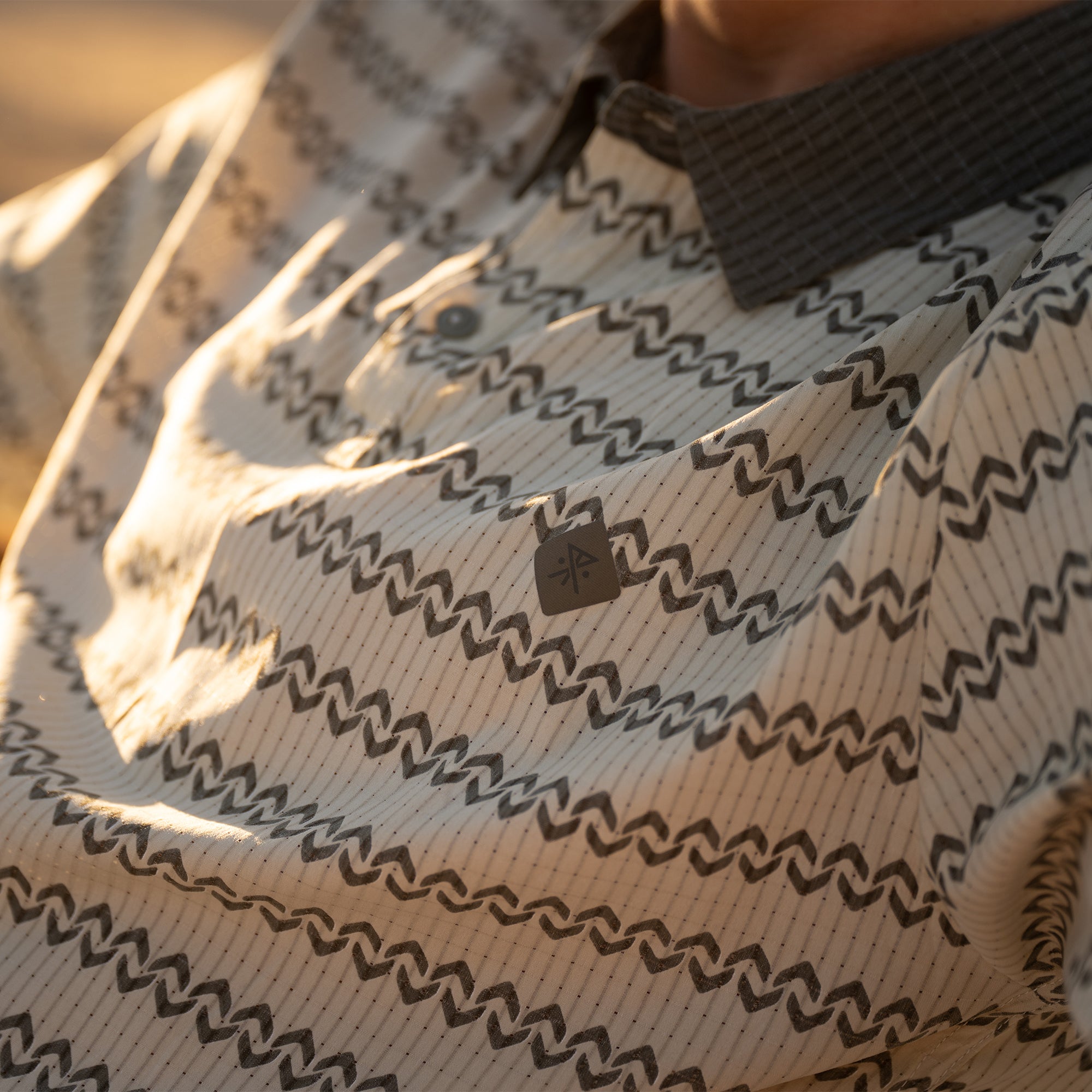 life-style-image Close-up of a Roark Baja-style shirt featuring a detailed pattern with a traditional collar and button design, perfect for outdoor and travel adventures.