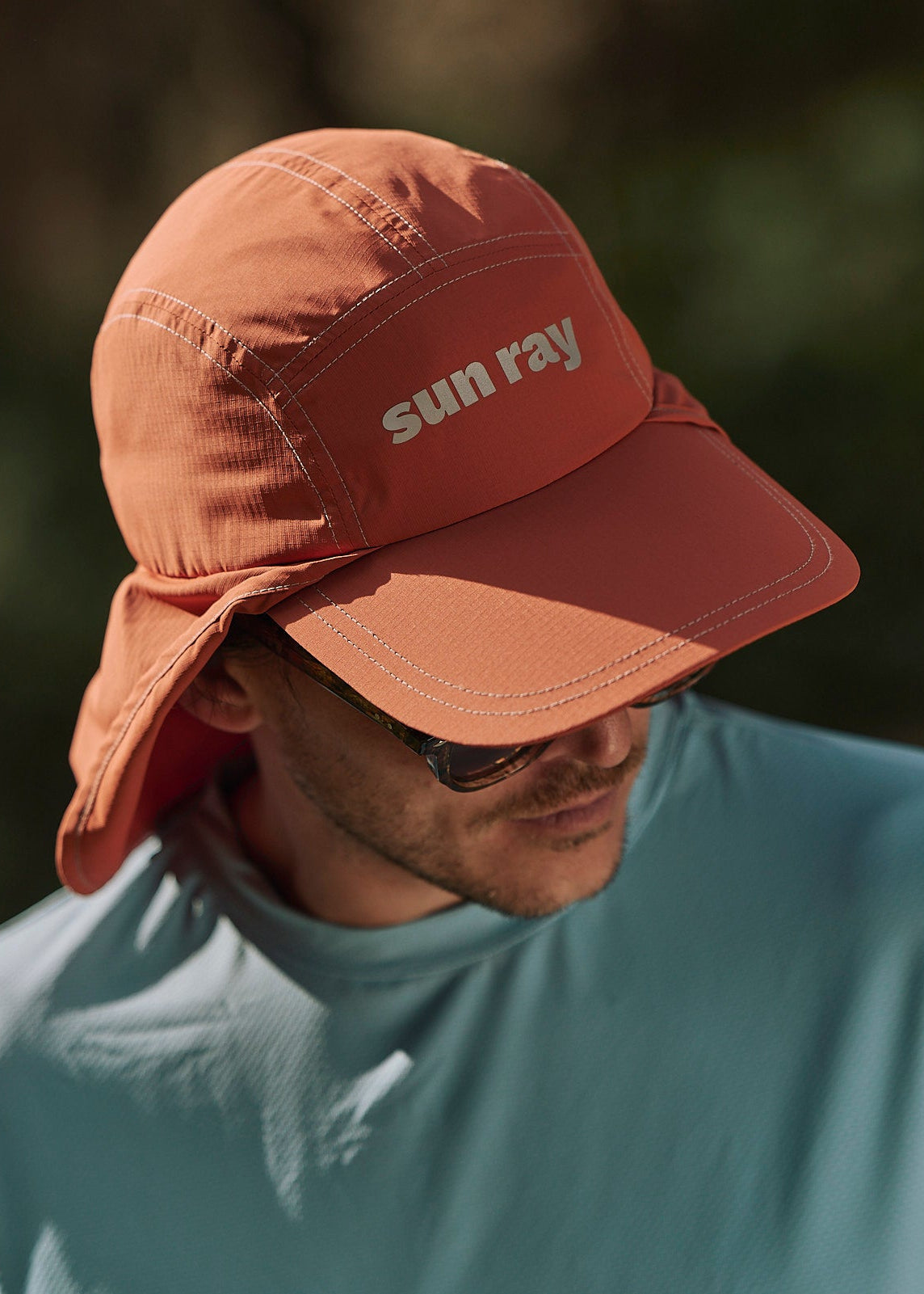 Person wearing an orange UPF50+ sun protection legionnaire hat