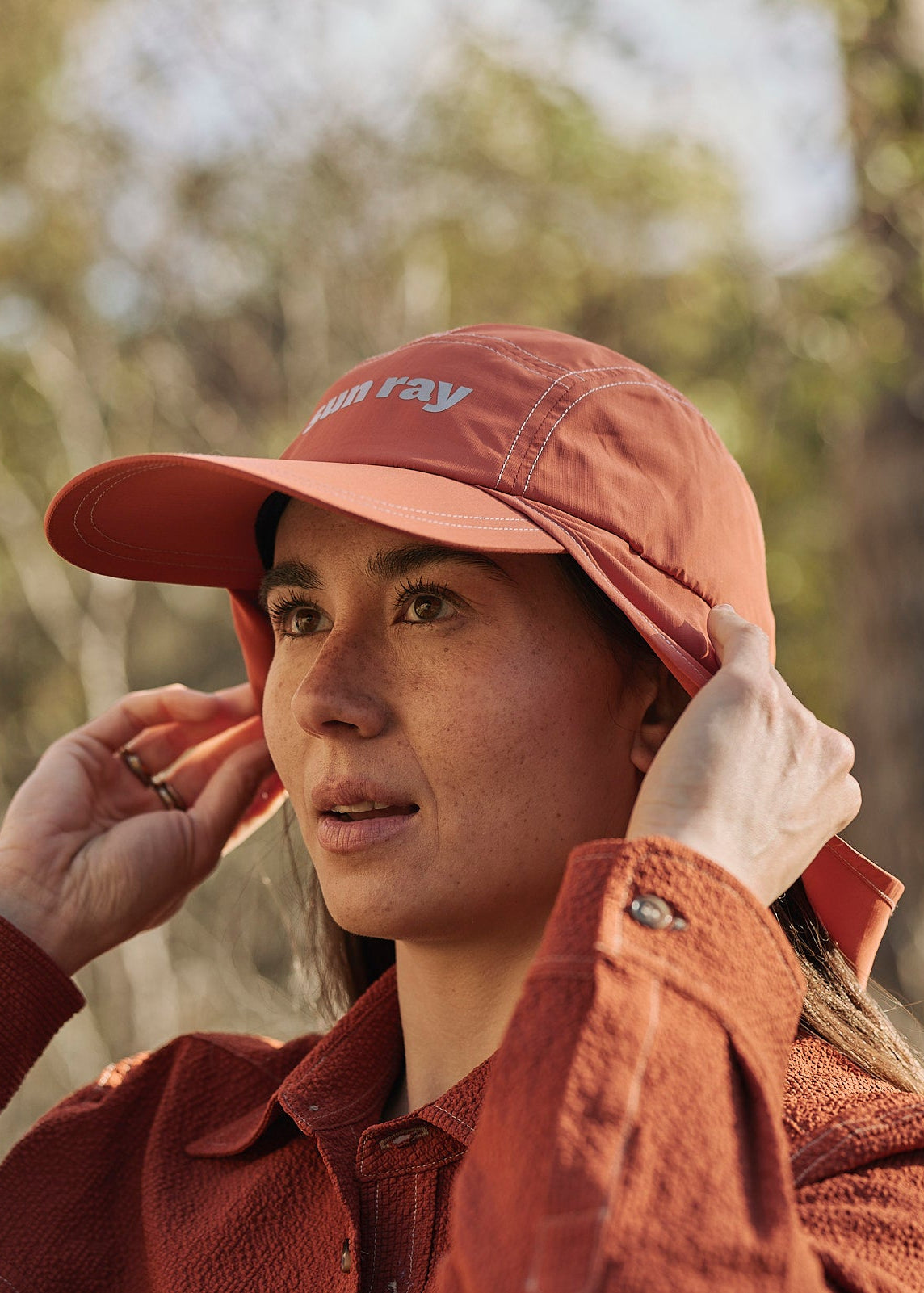 Person wearing an orange UPF50+ sun protection legionnaire hat