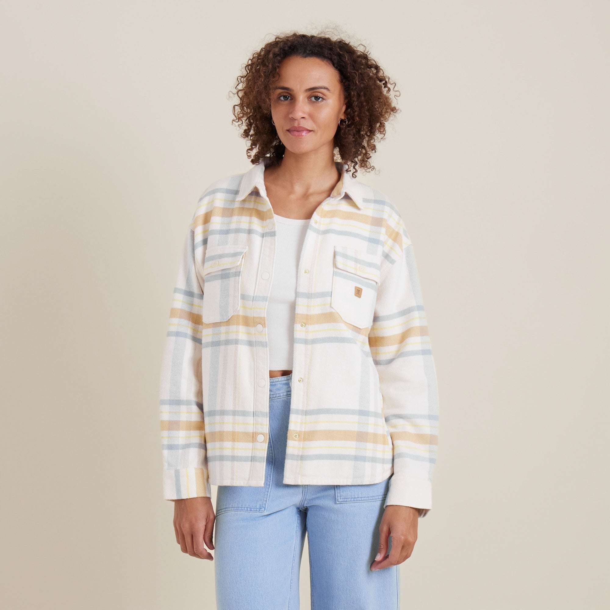 Front view of the Amberley Dusk plaid shirt by Roark, featuring soft pastel stripes and dual chest pockets for a casual, adventure-ready look.