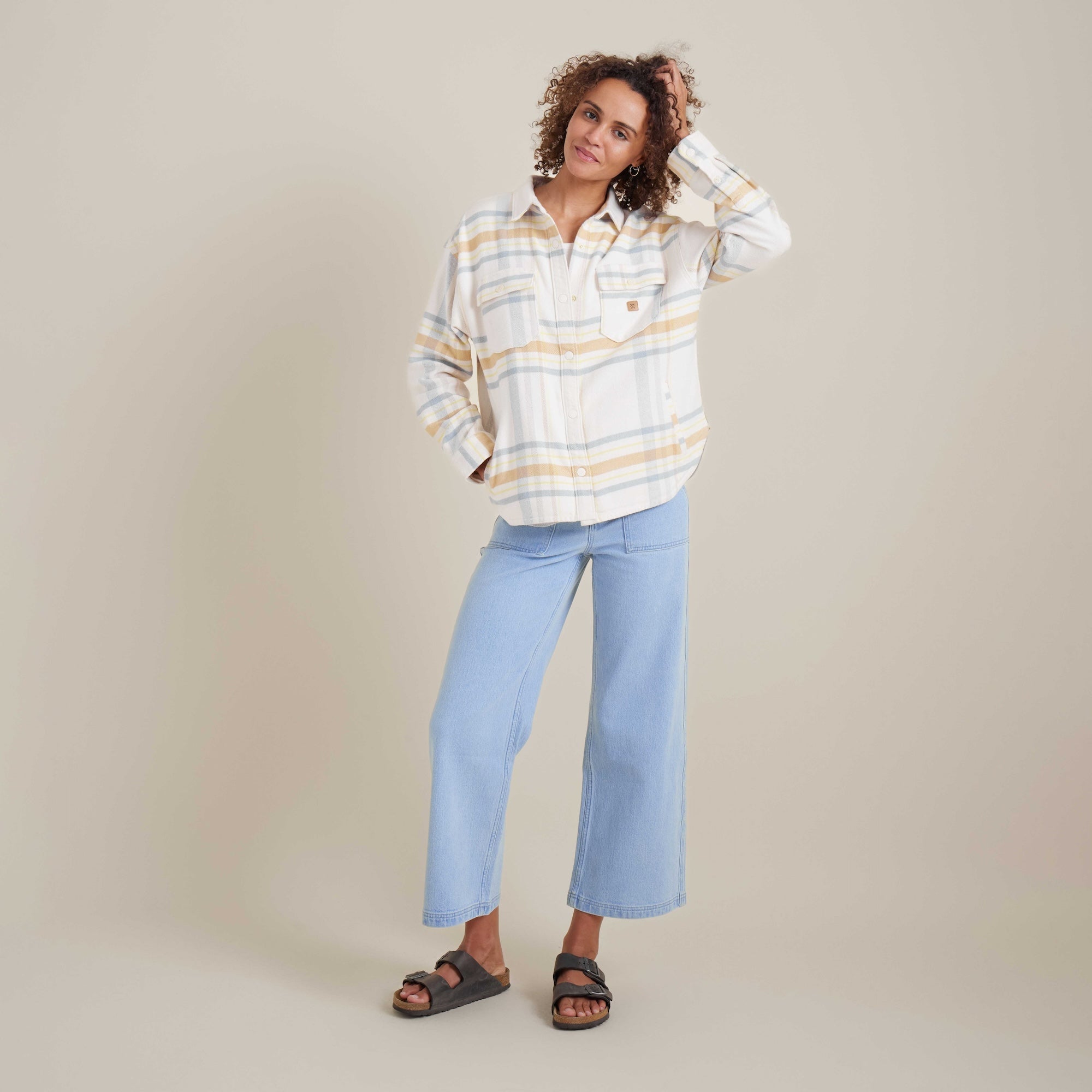 Full-body view of the Amberley Dusk plaid shirt by Roark, styled with light-wash jeans and sandals. Ideal for outdoor exploration and everyday wear.