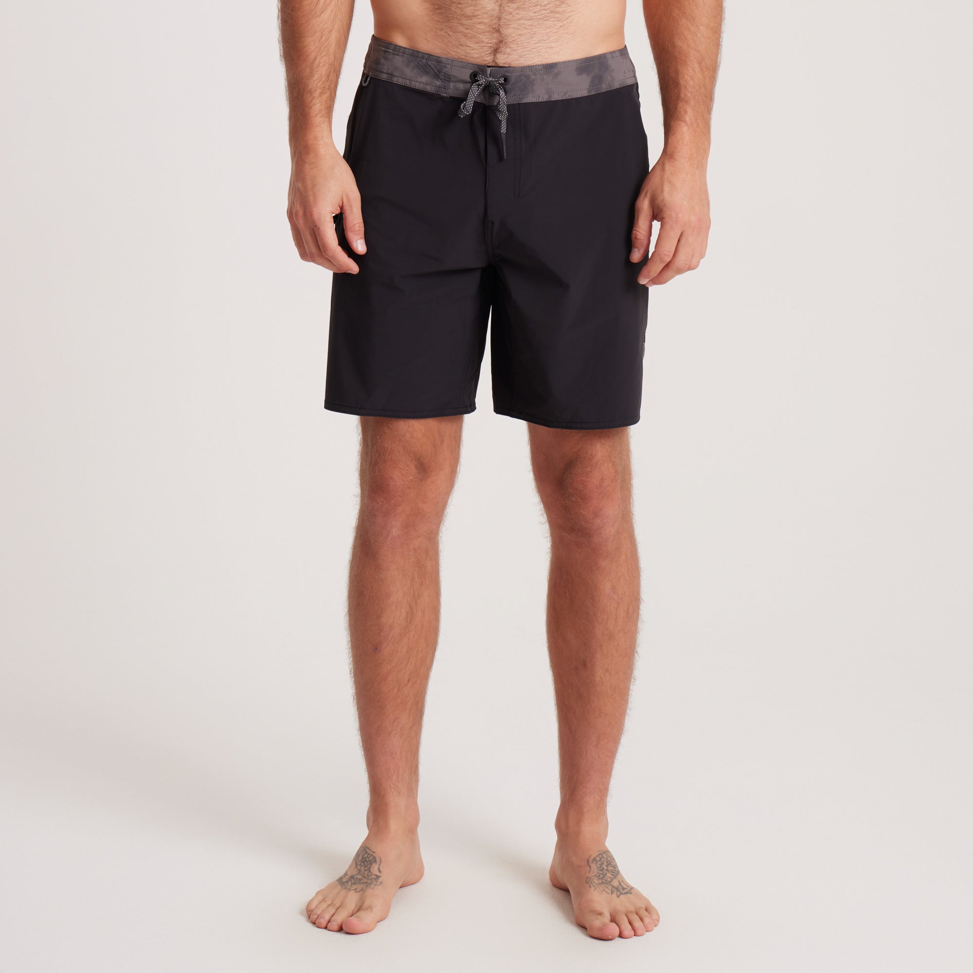 Front view of black Roark boardshorts with a grey waistband, designed for comfort, durability, and water performance.