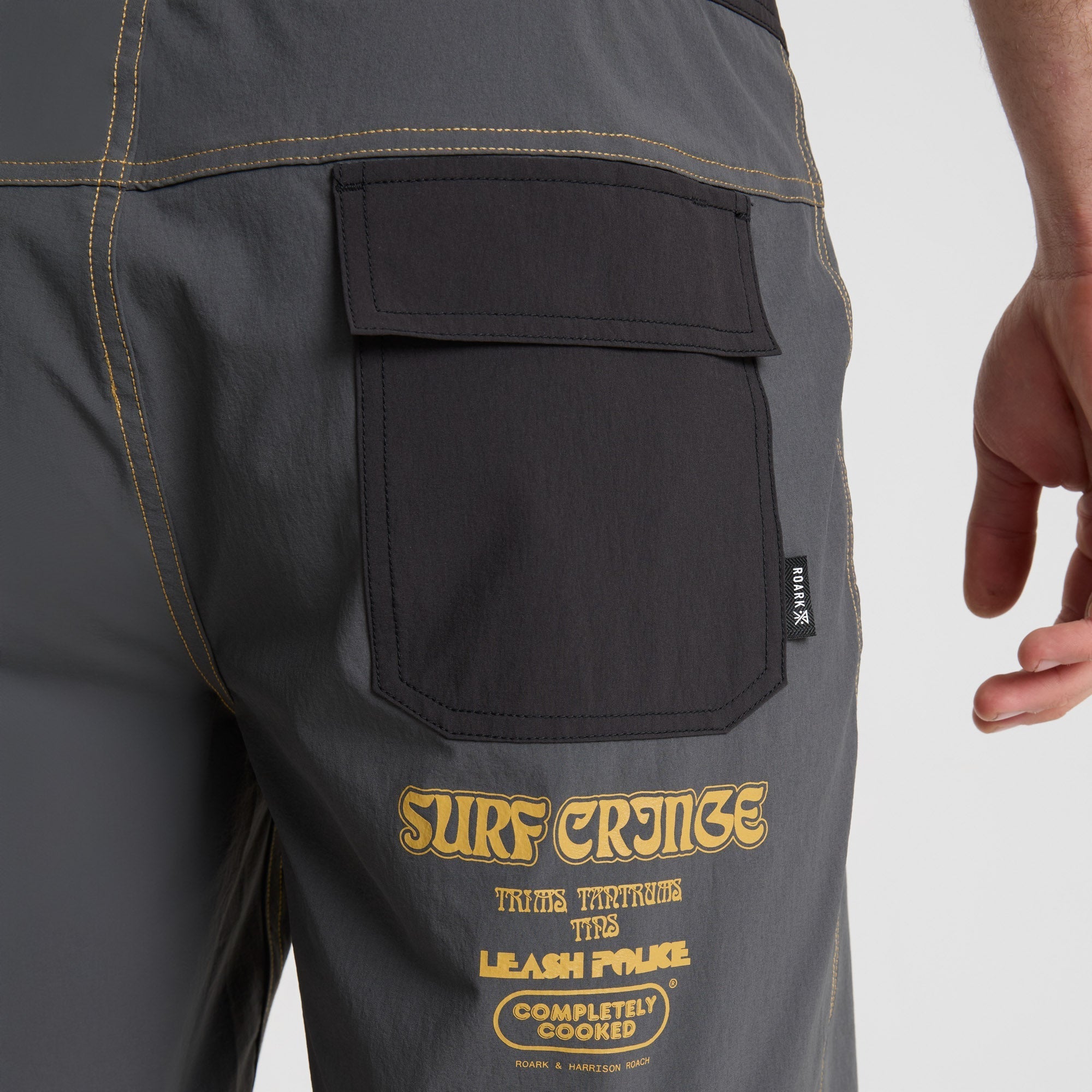 Assortment of Roark adventure-ready shorts including cargo pants and Bermuda boardshorts, featuring multiple pockets, ideal for travel and outdoor activities.