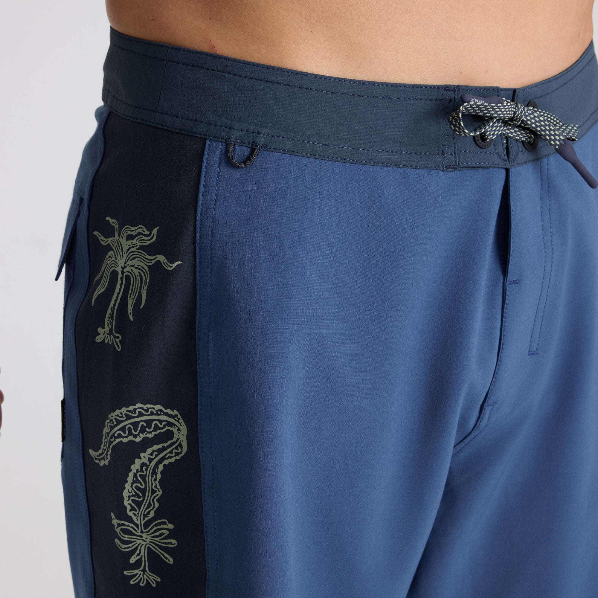 Bermuda shorts and wetsuit on display, showcasing Roark's adventure-ready apparel for diverse outdoor activities.