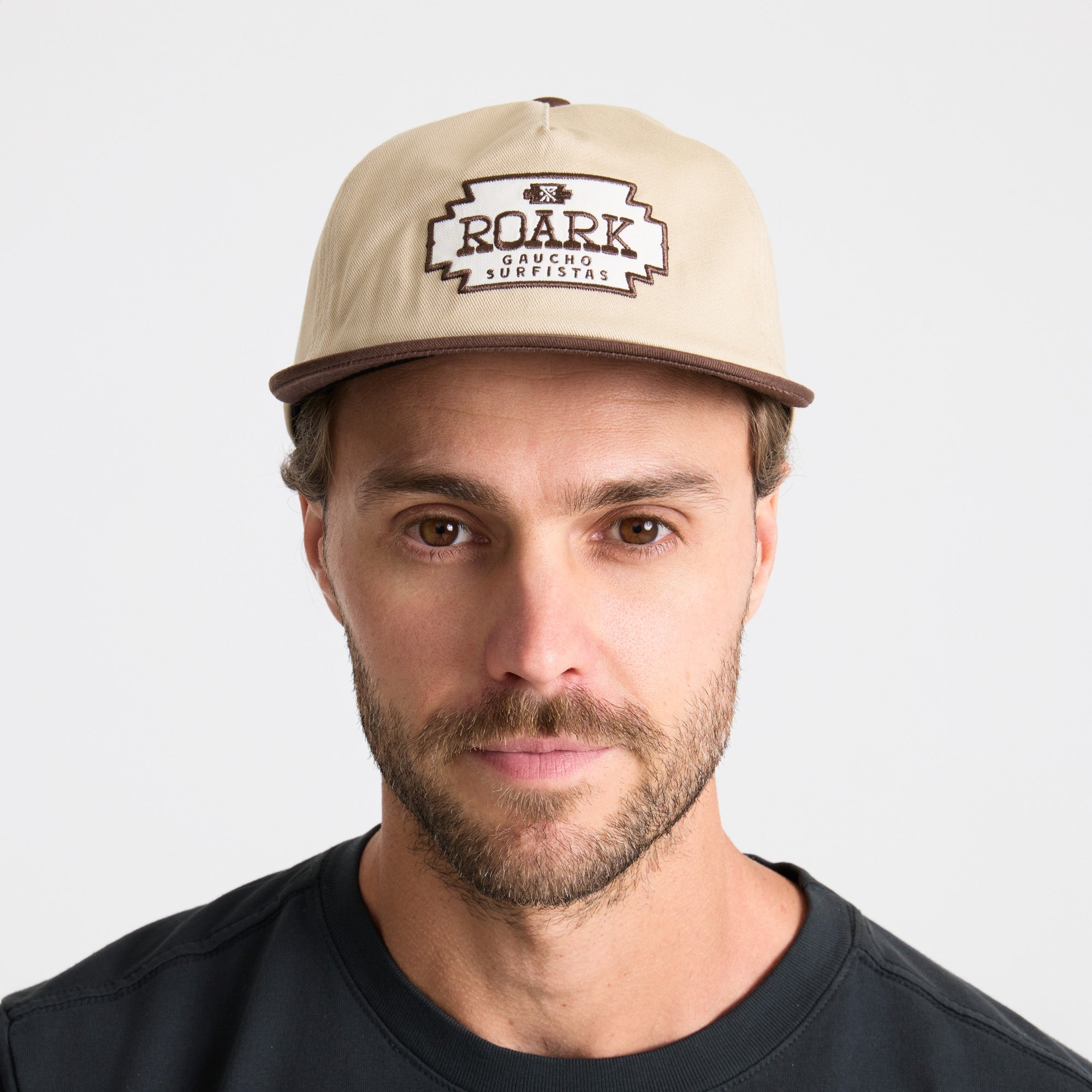 Man with a rugged beard wearing a versatile Roark cap on an adventure.
