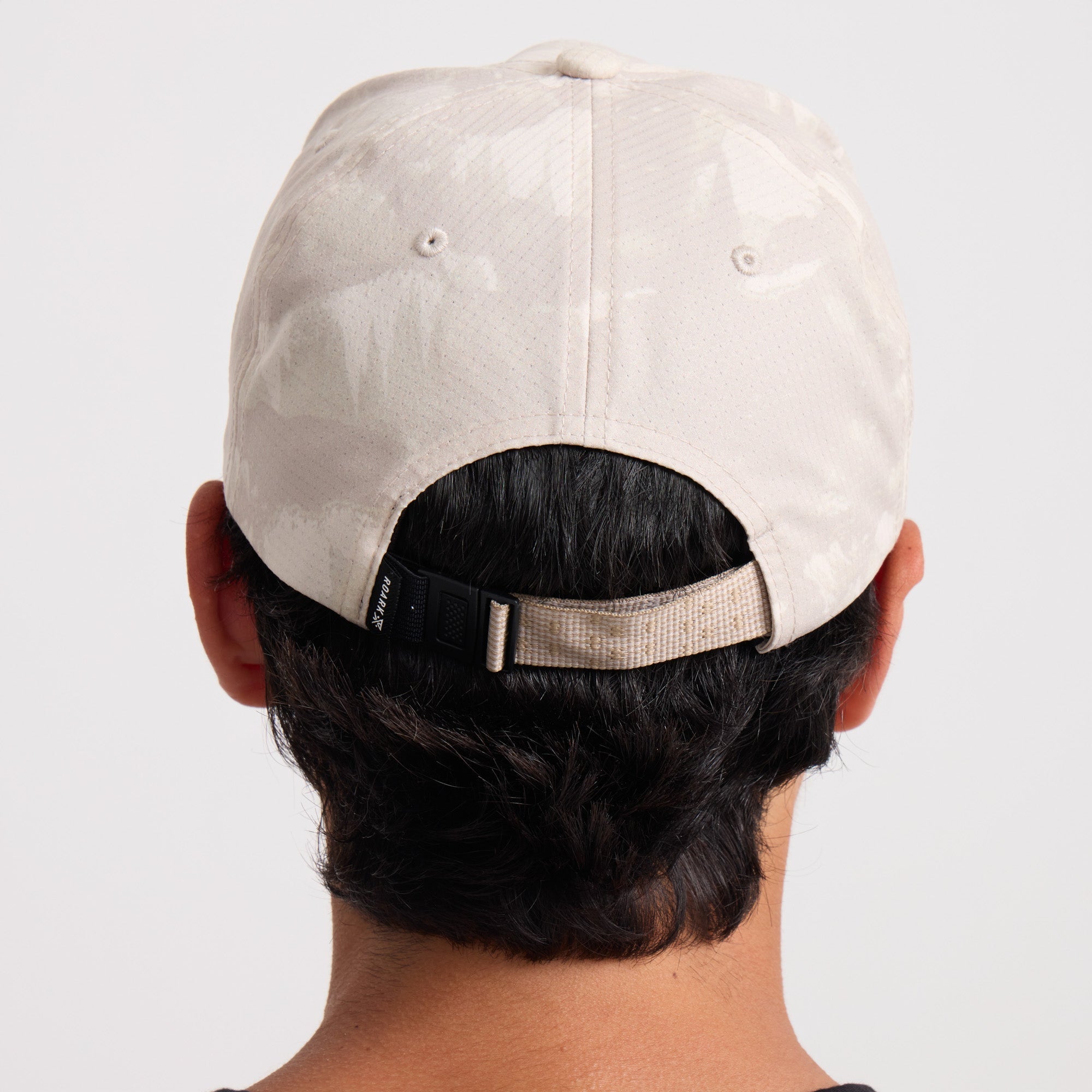 Stylish adventure-ready Roark baseball cap showcased outdoors, ideal for travel and exploration.