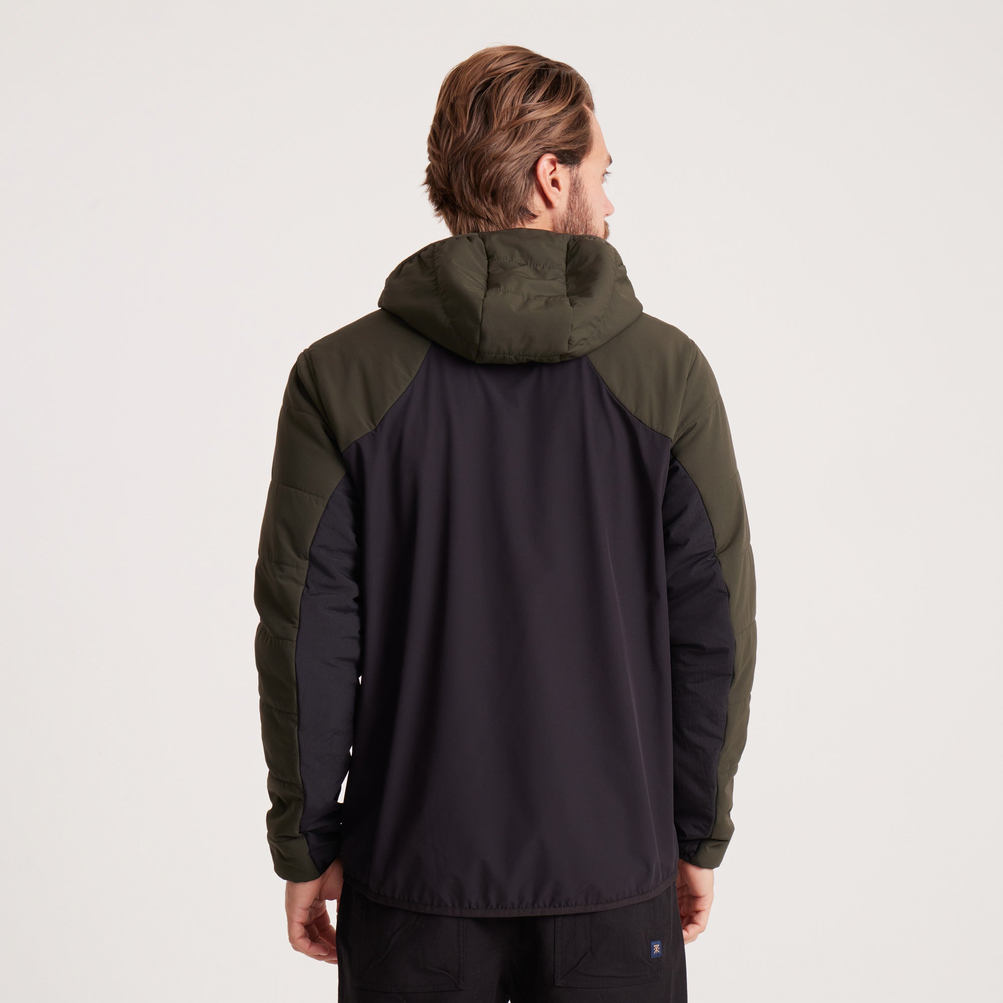 Back view of a green and black hooded jacket, designed for comfort and weather resistance in outdoor settings.