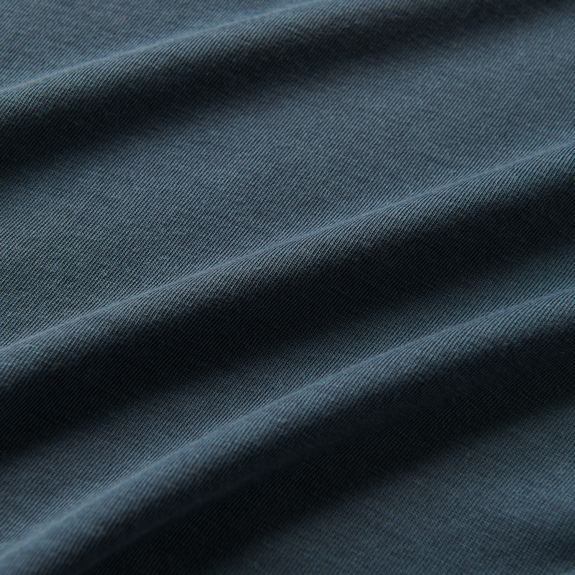 A close-up image of the Roark Mathis Core Short Sleeve Tee in blue, showcasing the details and craftsmanship. Shop the official Roark store now.