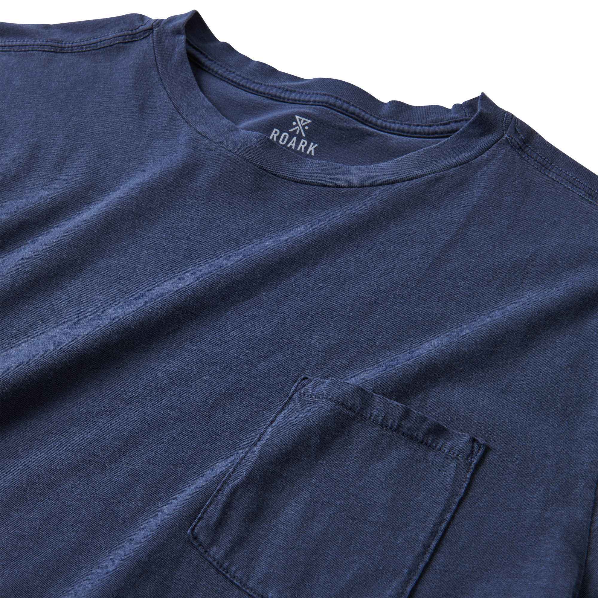 A close-up image of the Roark Made To Fade Short Sleeve Tee in Washed Navy, showcasing the details and craftsmanship. Shop the official Roark store now.