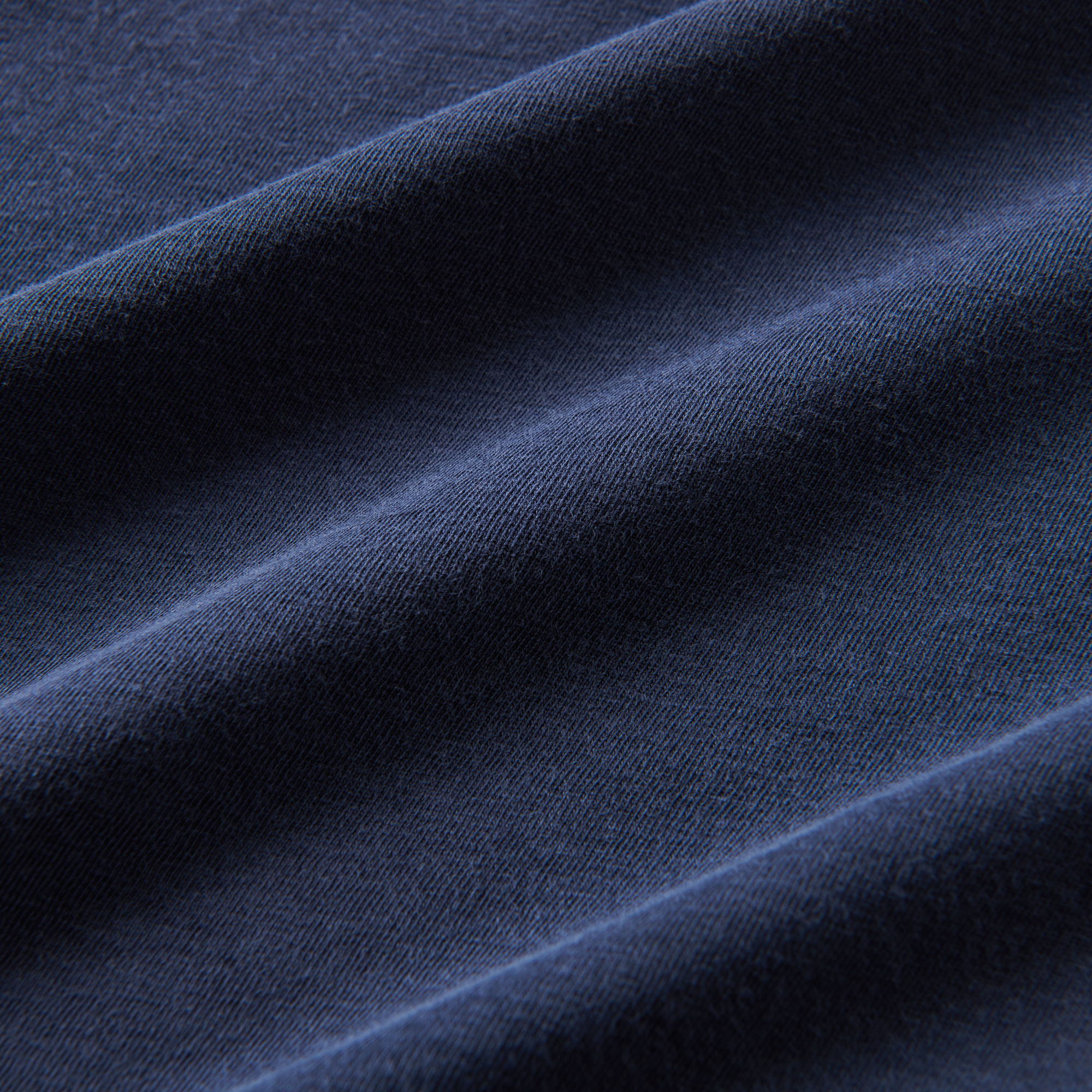 A close-up image of the Roark Made To Fade Short Sleeve Tee in Washed Navy, showcasing the details and craftsmanship. Shop the official Roark store now.