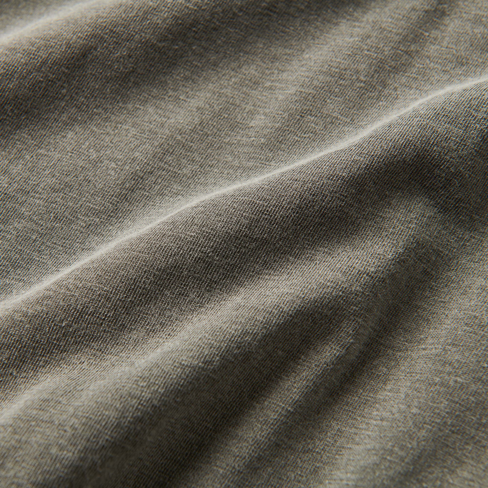 A close-up image of the Roark Made To Fade Short Sleeve Tee in Washed Military, showcasing the details and craftsmanship. Shop the official Roark store now.