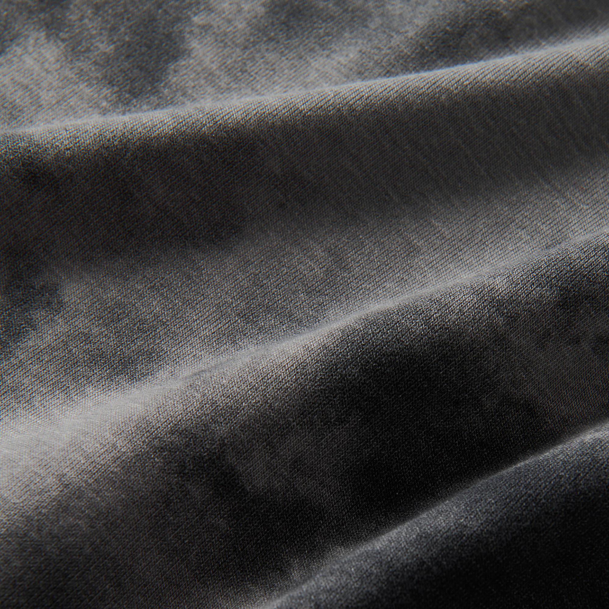 Detail of rugged denim and silver woven fabric with fur texture, embodying Roark's adventurous outdoor aesthetic.