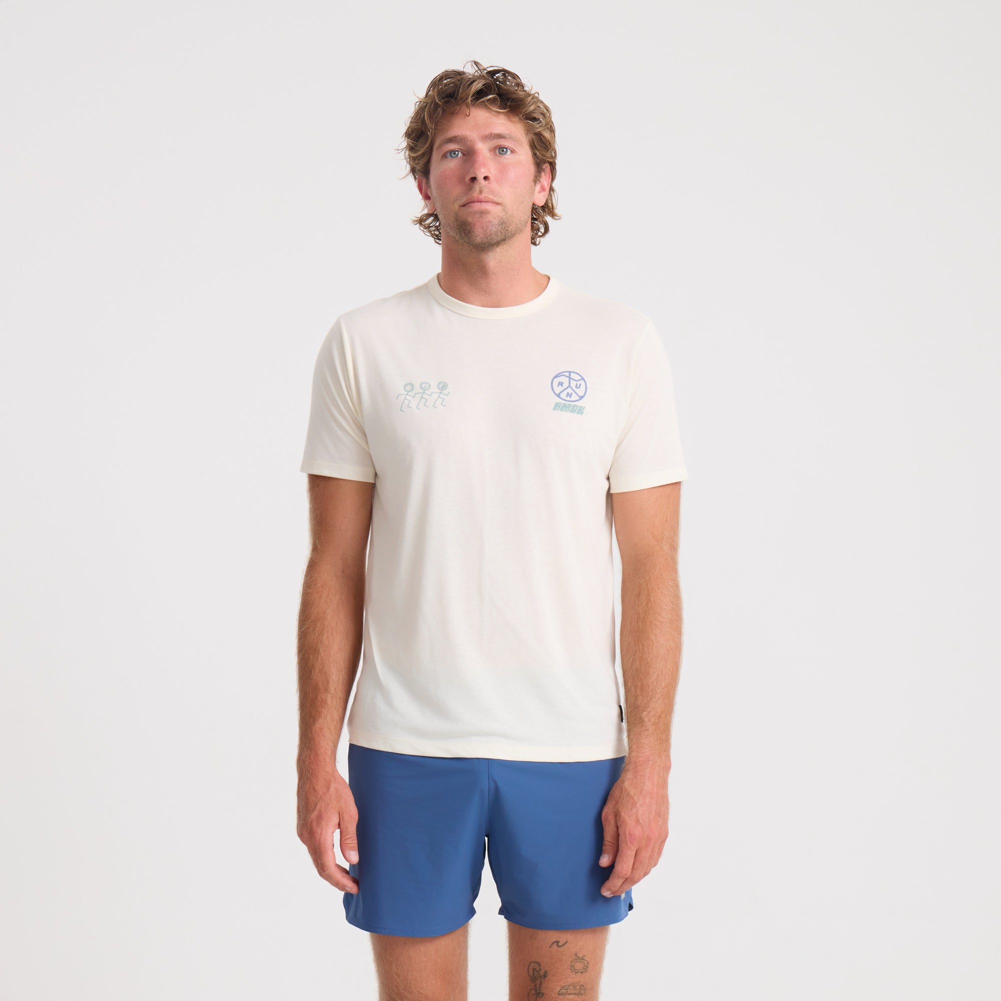 Man wearing blue active shirt and boardshorts engaged in outdoor adventure activities, showcasing Roark's style and durability in active wear.