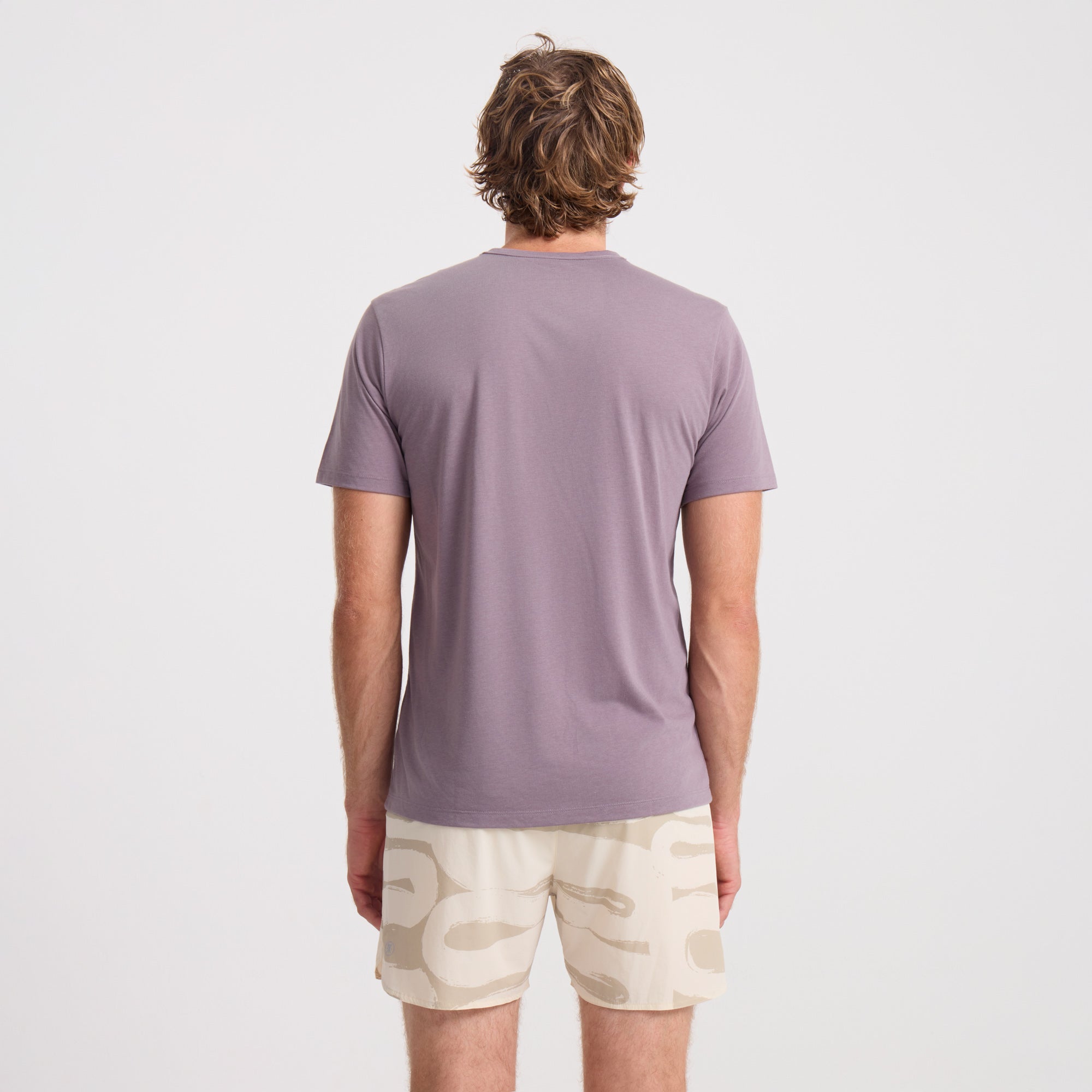 Active person wearing a grey Roark sleeve shirt with matching boardshorts, ready for an adventurous day outdoors.