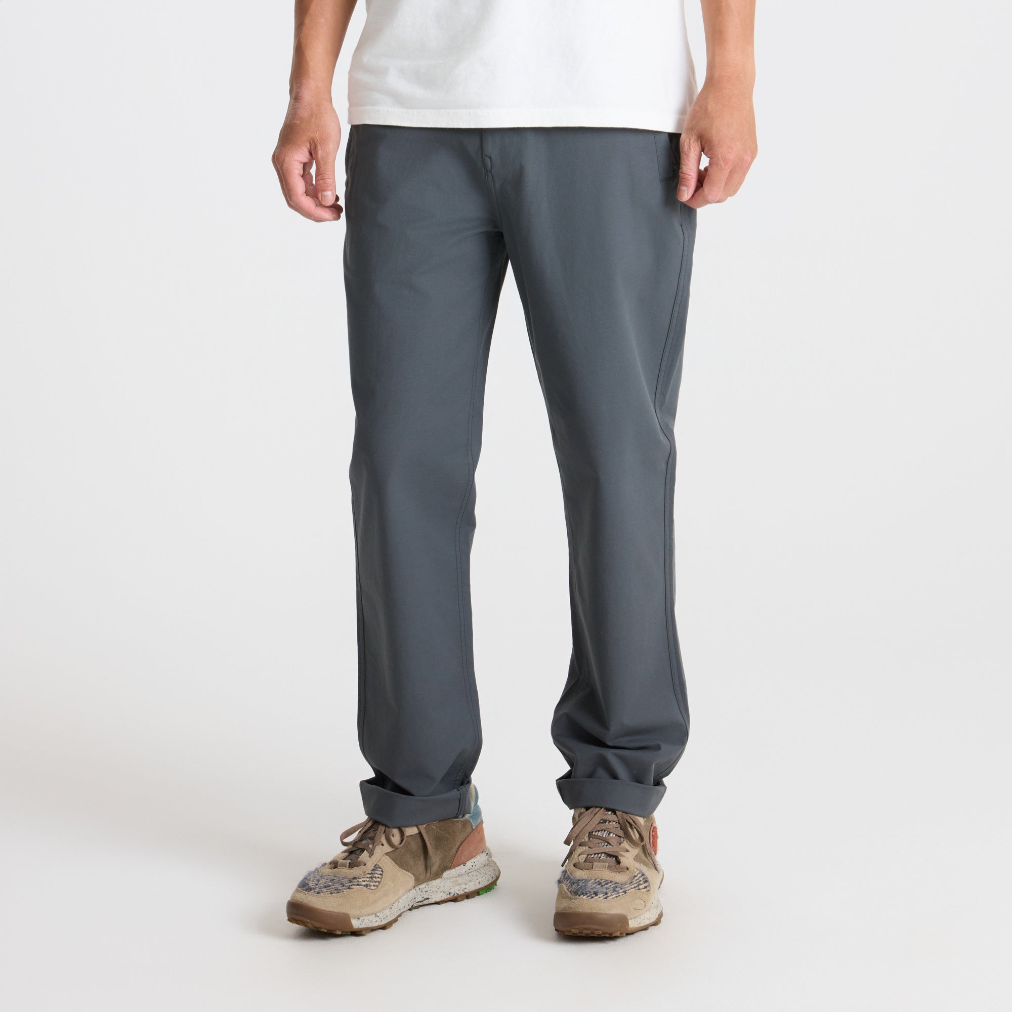 Roark outdoor adventure outfit featuring durable active pants and rugged shoes, perfect for trail and travel