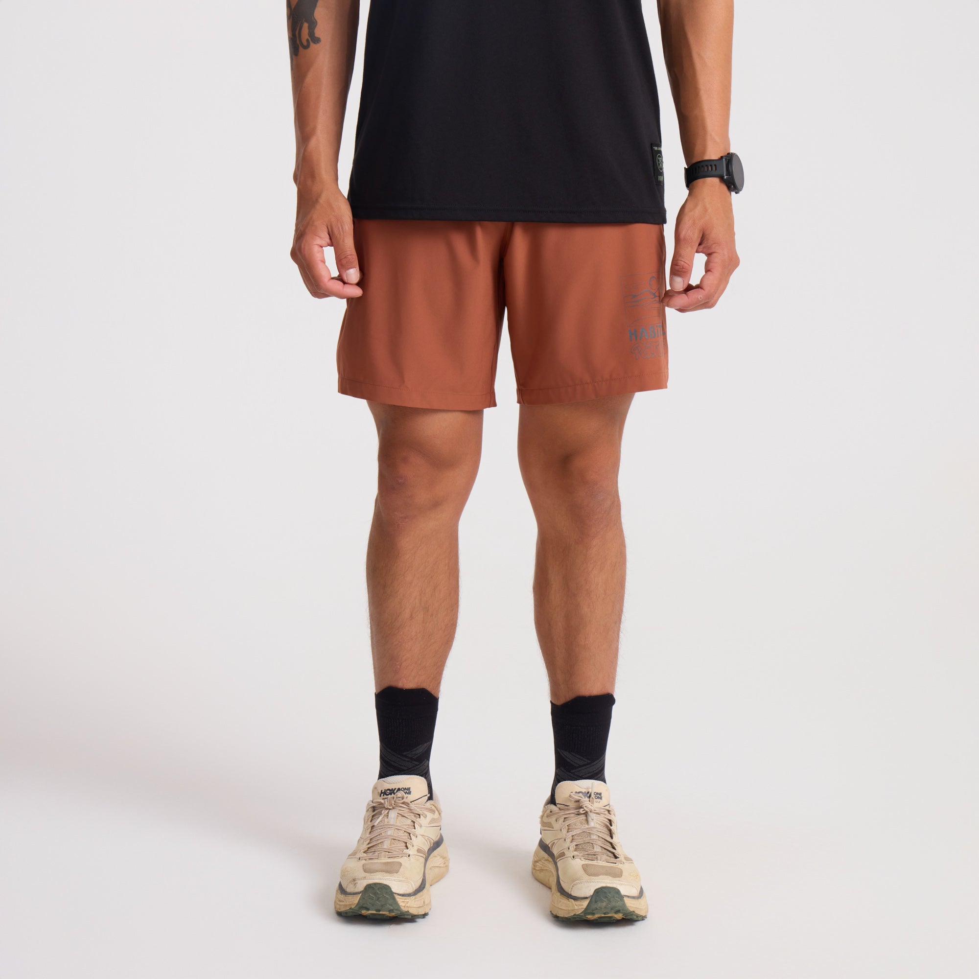 Bermuda shorts and visible calf in an outdoor adventure setting, perfect for travel and exploration.