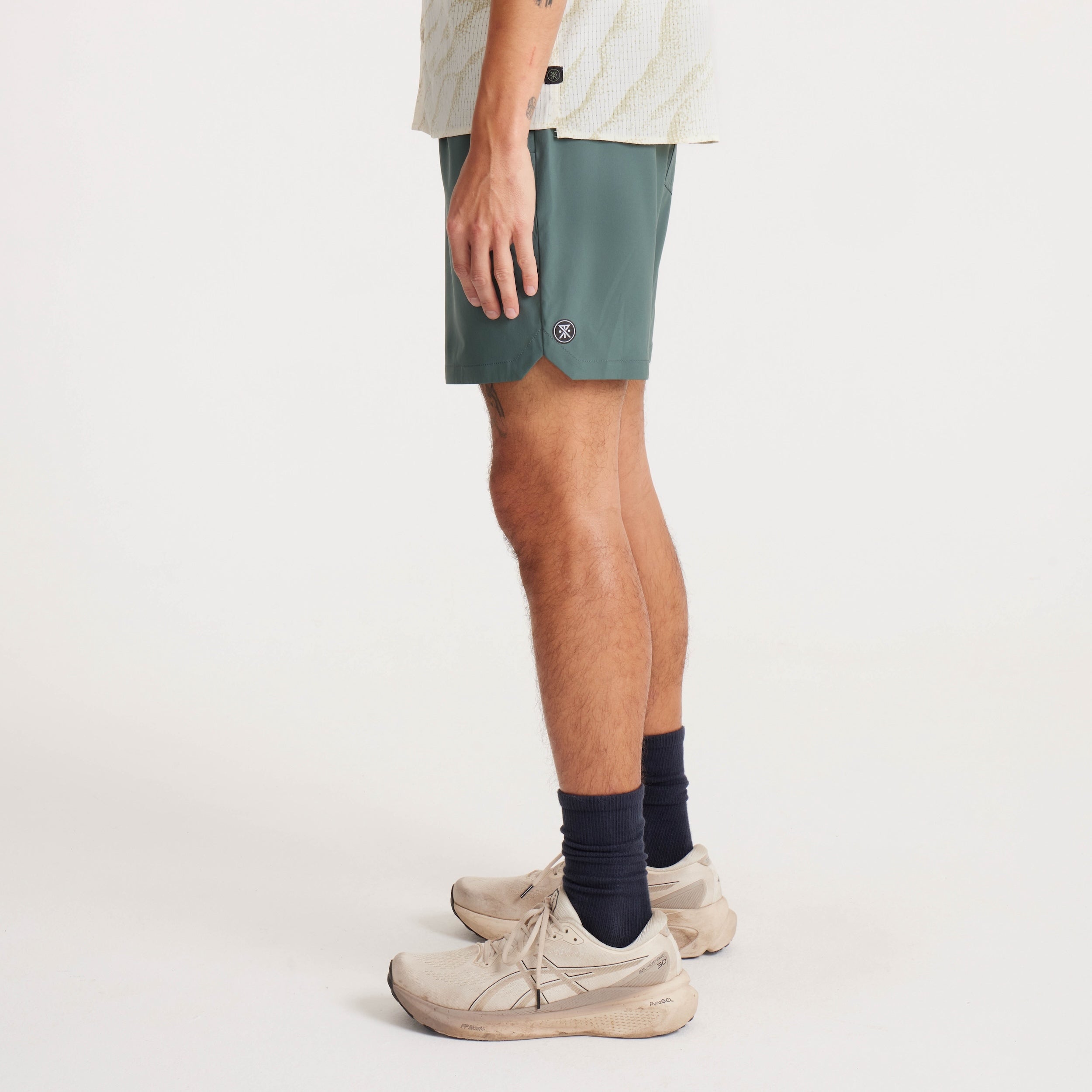 Side angle showing the fit and mobility of men's green shorts, ideal for active and casual wear.
