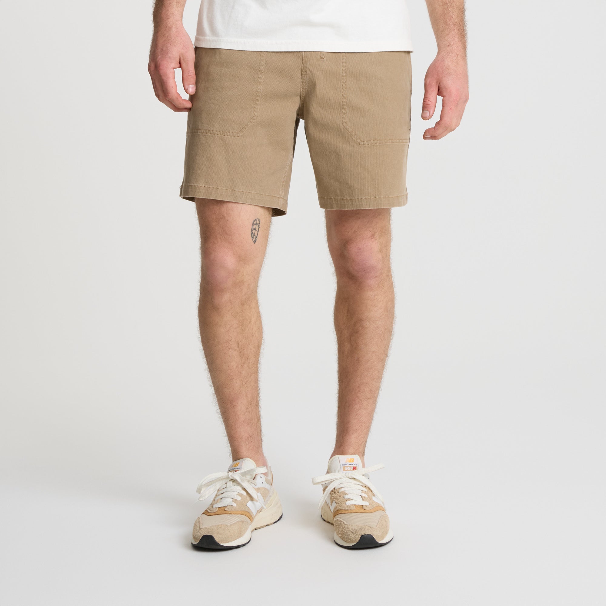 Man wearing versatile Roark boardshorts ready for outdoor adventure, showcasing the ideal combination of comfort and style for the active traveler
