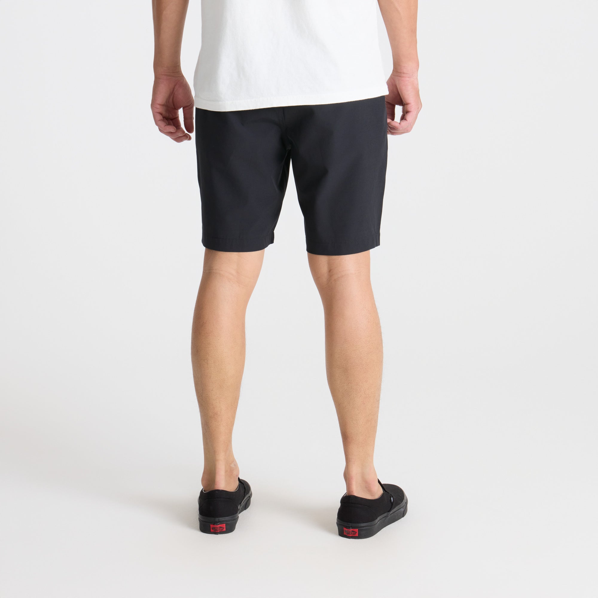 Adventurous calf wearing bermuda shorts and walking shoes in an outdoor setting, embodying Roark's spirit of exploration and travel.