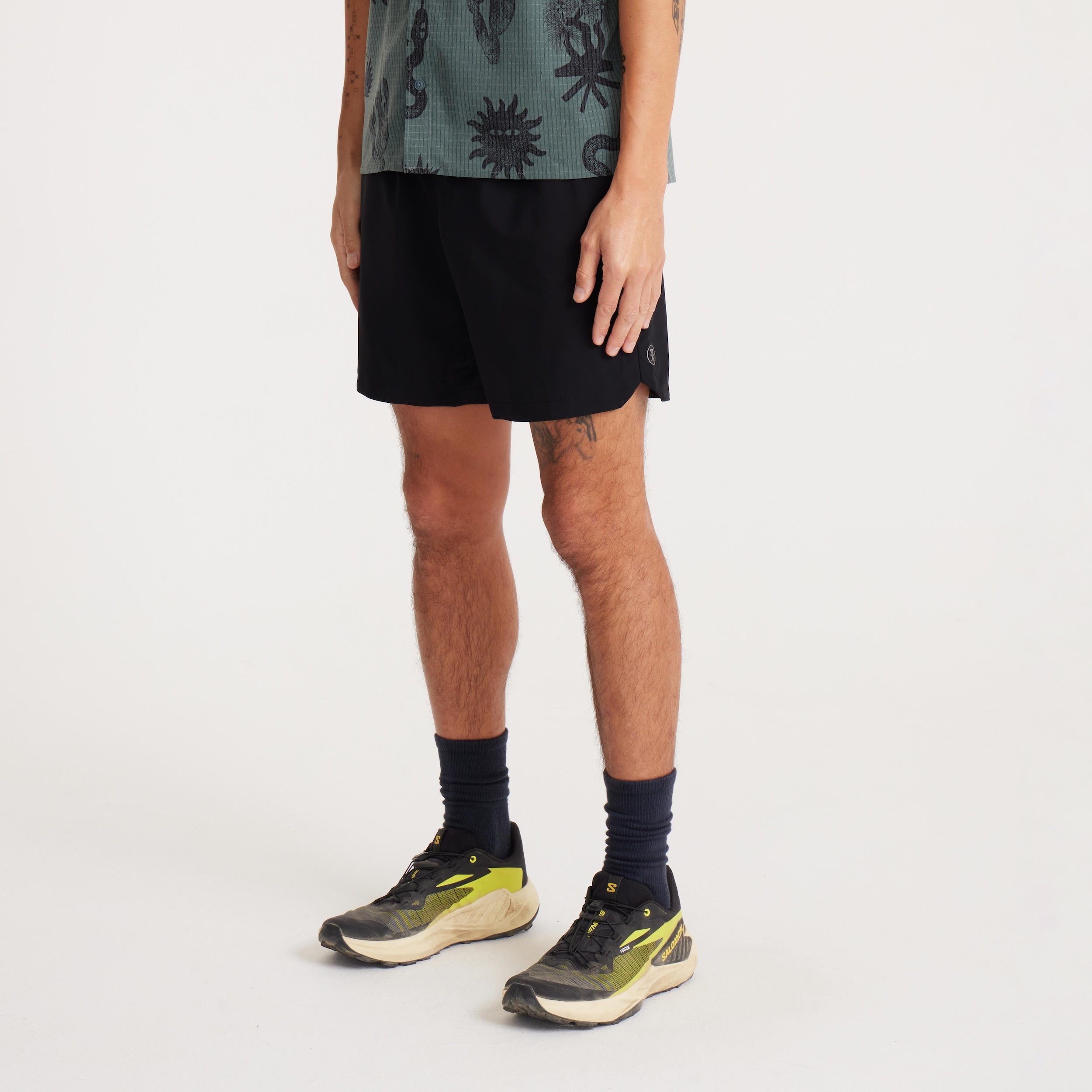 Side-front view of black Serrano shorts worn by model, highlighting the sleek fit and slash pockets for active or everyday wear.