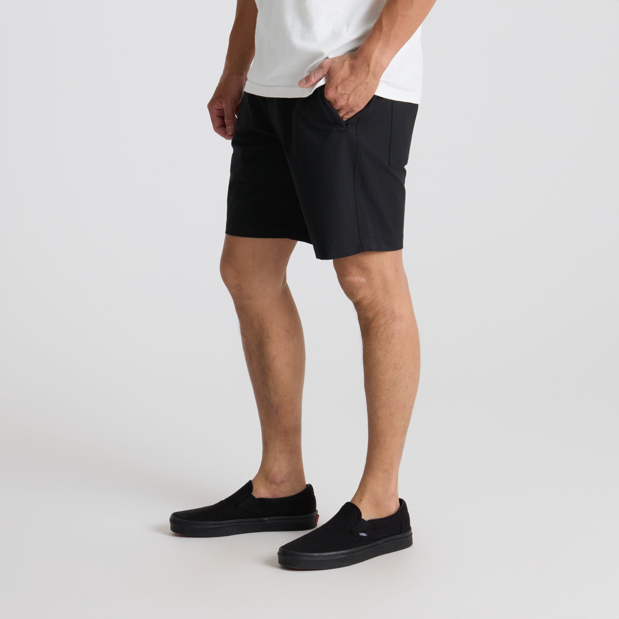 Close-up of black Roark adventure shorts showcasing the fit from calf to thigh, ideal for outdoor activities.
