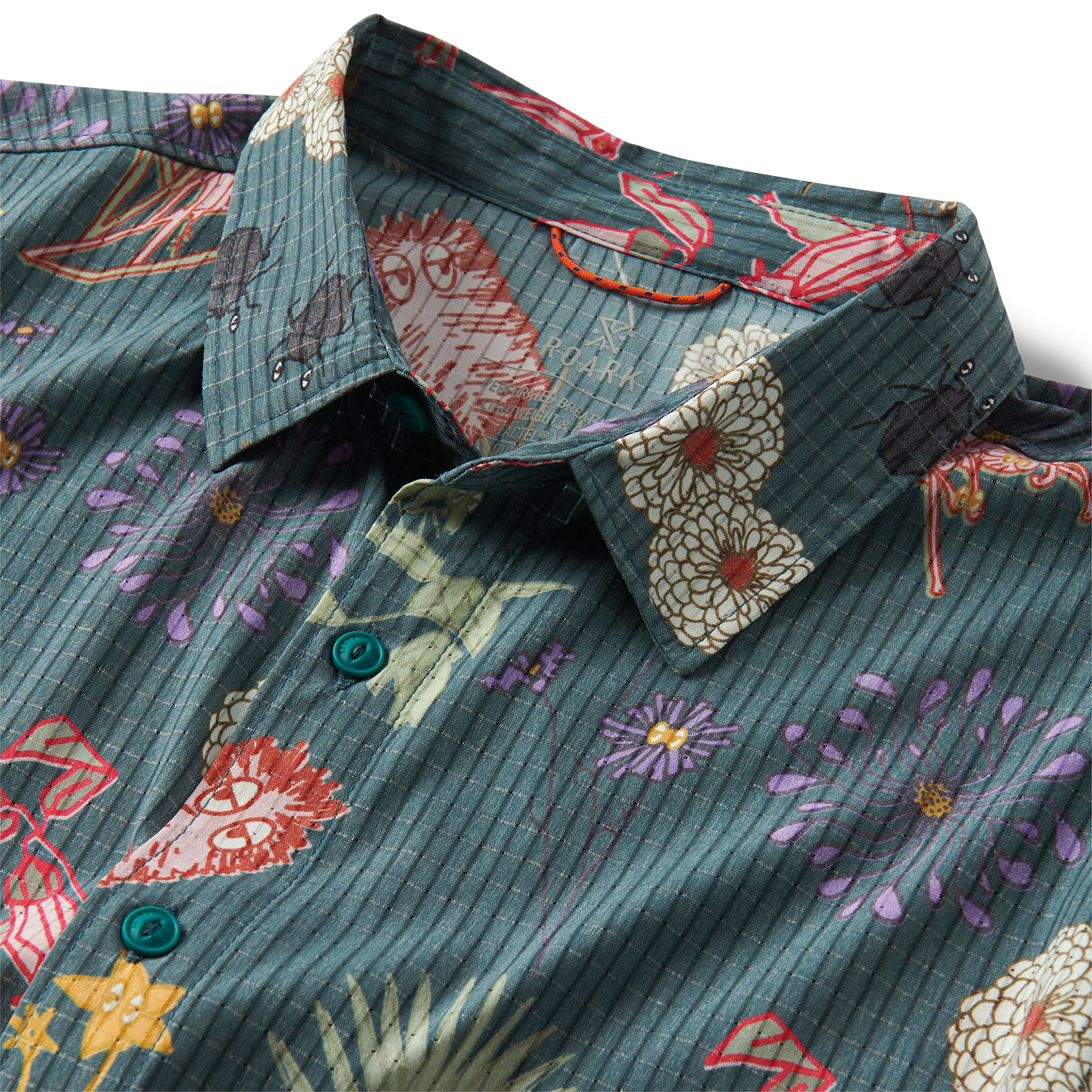 Close-up of a patterned Roark dress shirt featuring detailed collar and button design, perfect for adventure and travel.