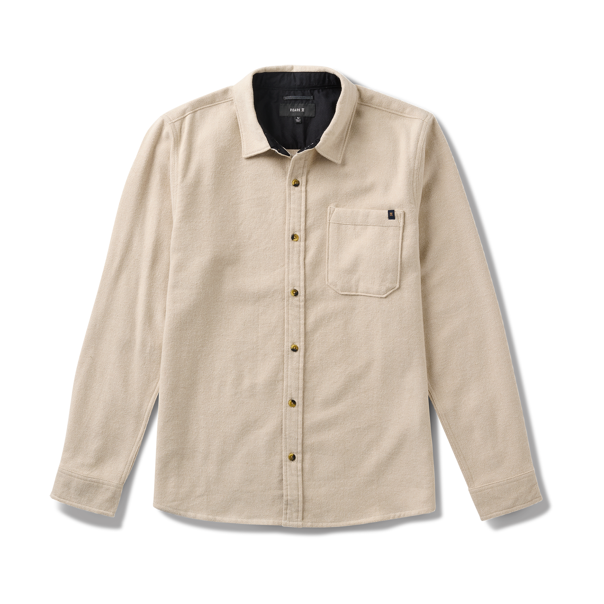 Close-up of a durable button on Roark gear, designed for adventure and outdoor activities.