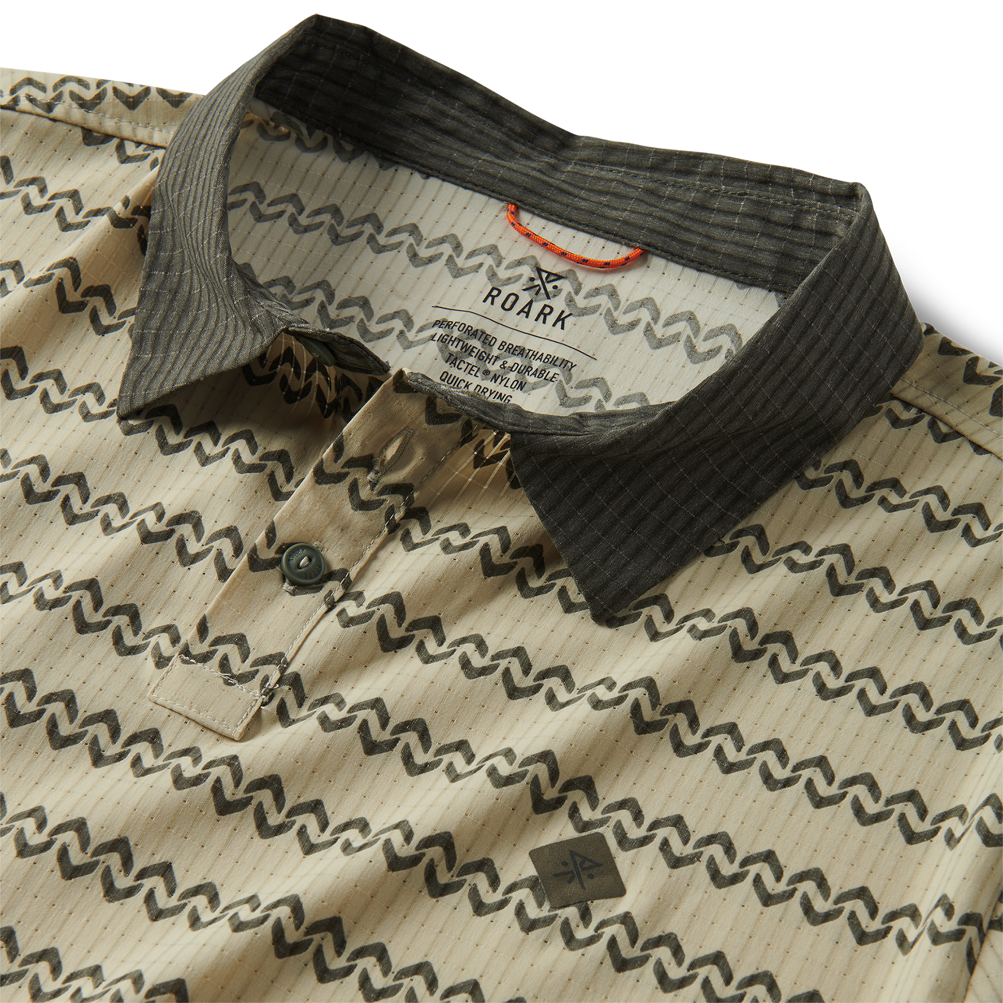 Detail of a stylish dress shirt featuring a collar, intricate pattern, and buttons, embodying Roark's spirit of adventure and travel.