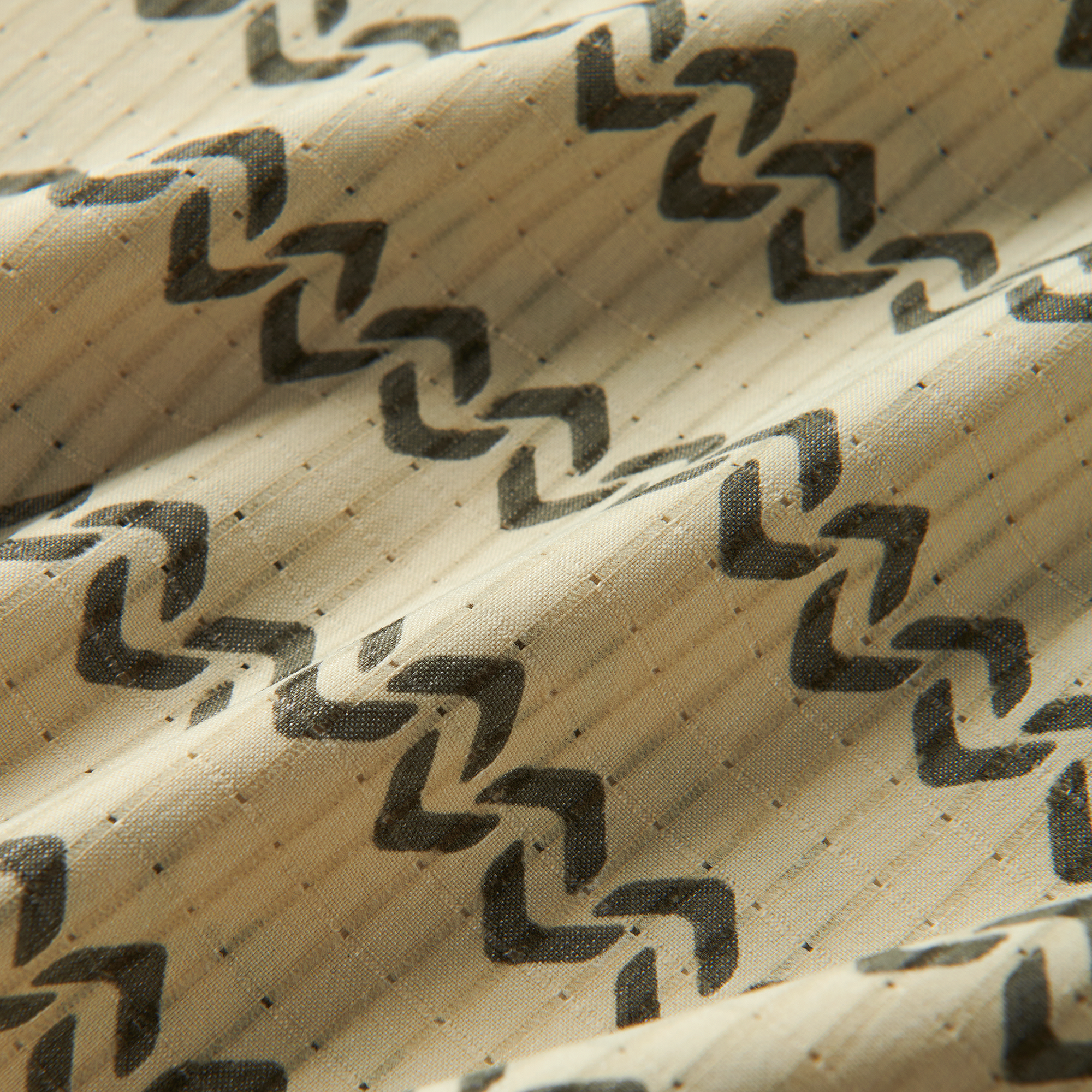 Close-up of rugged brown woven fabric with a distinctive pattern, embodying Roark’s adventure-ready textiles.