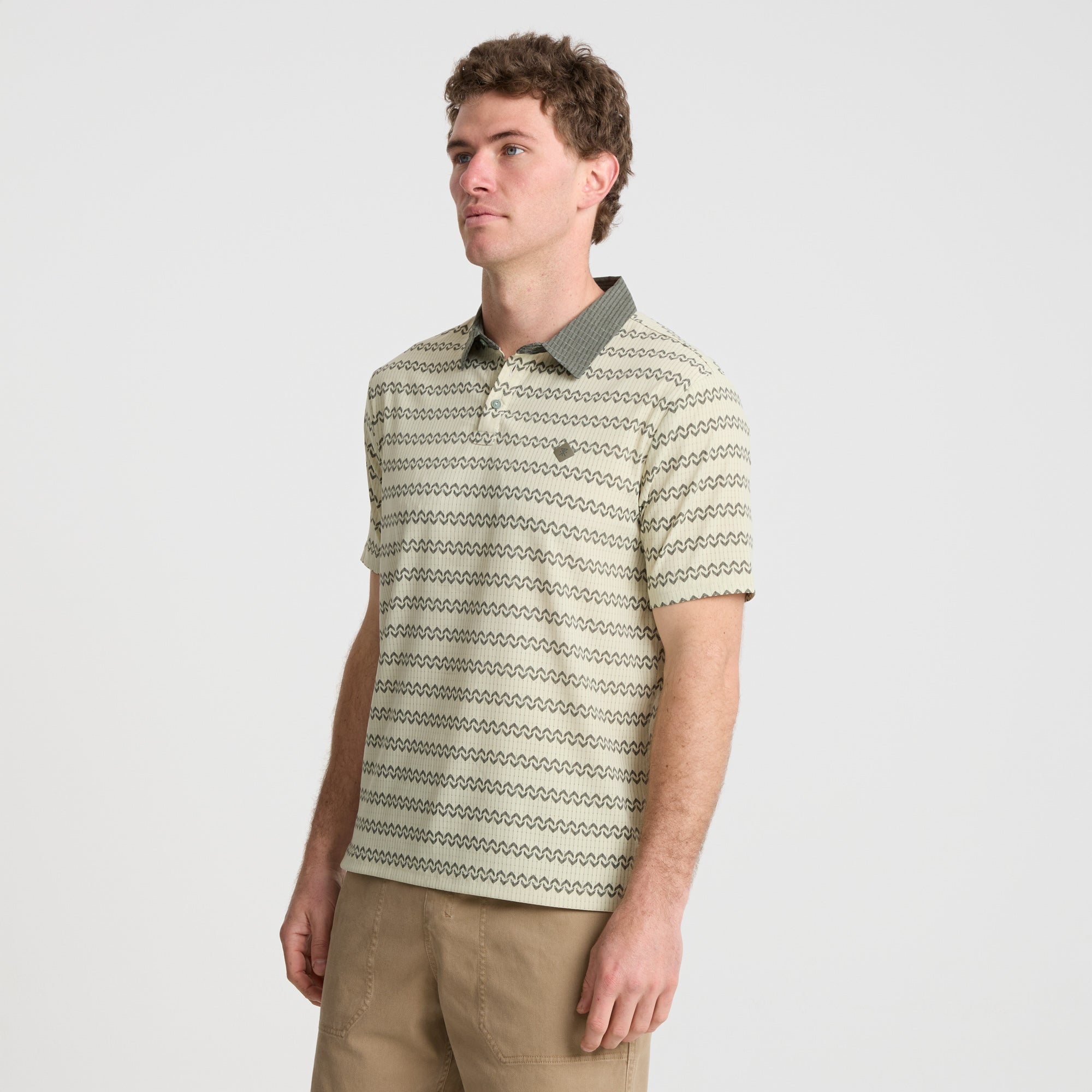 on-model Close-up of a durable Roark polo shirt featuring a collar, buttons, and active design perfect for outdoor adventures.