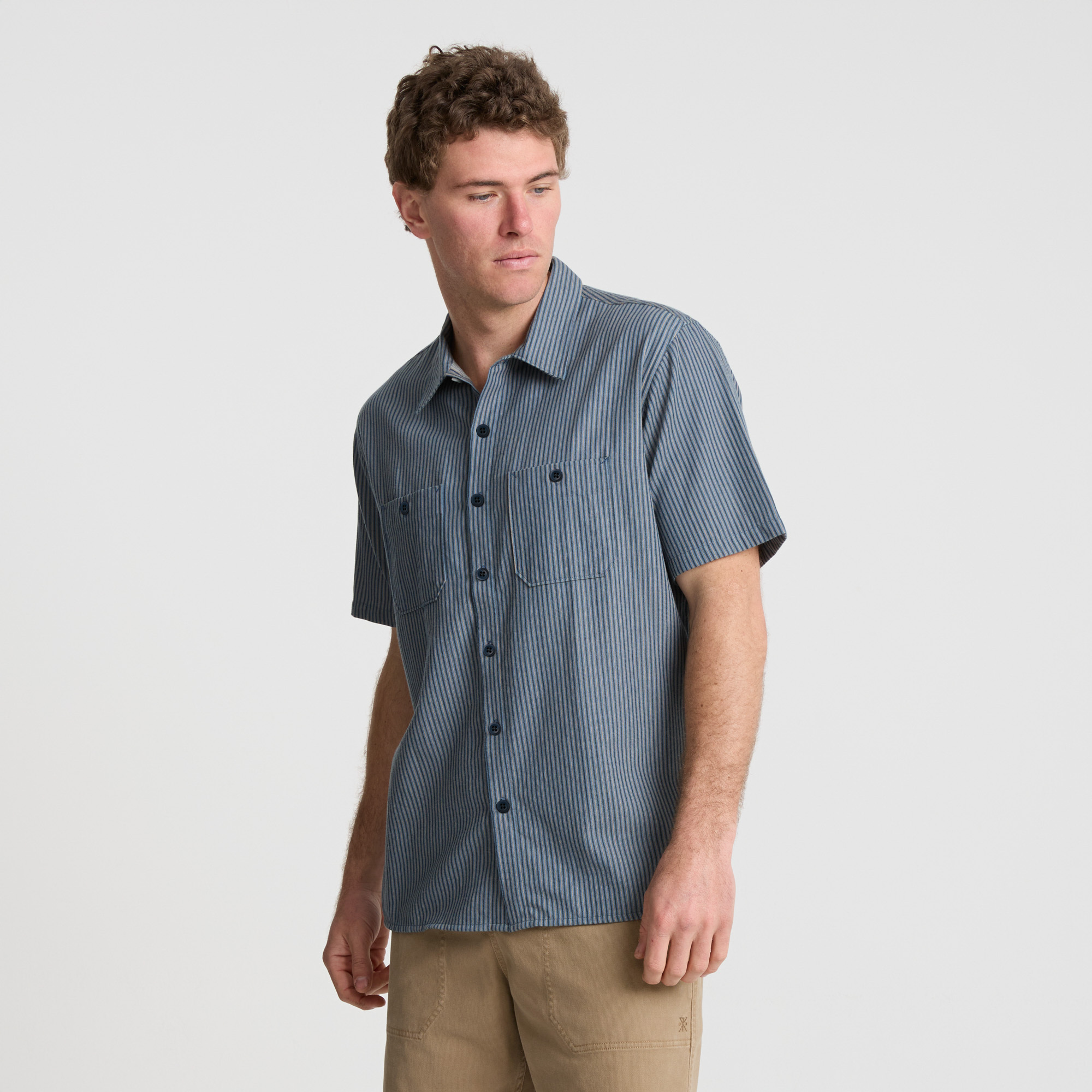 Stylish adventurer wearing a classic fedora and dress shirt with detailed collar and buttons, ready for a journey